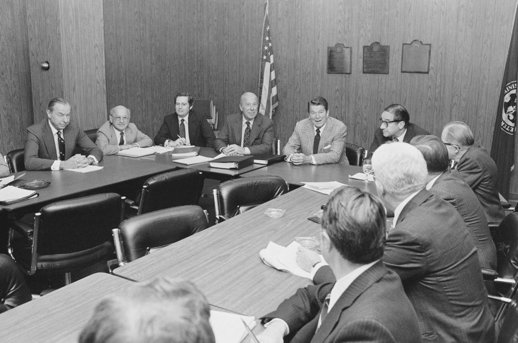 Then President elect Ronald Reagan meets with his top economic advisers at the Los Angeles Federal Building on Nov. 16, 1980, including (from left): Walter Wriston, Milton Friedman, Daryl Trent, George Shultz, Ronald Reagan, and Paul McCracken.