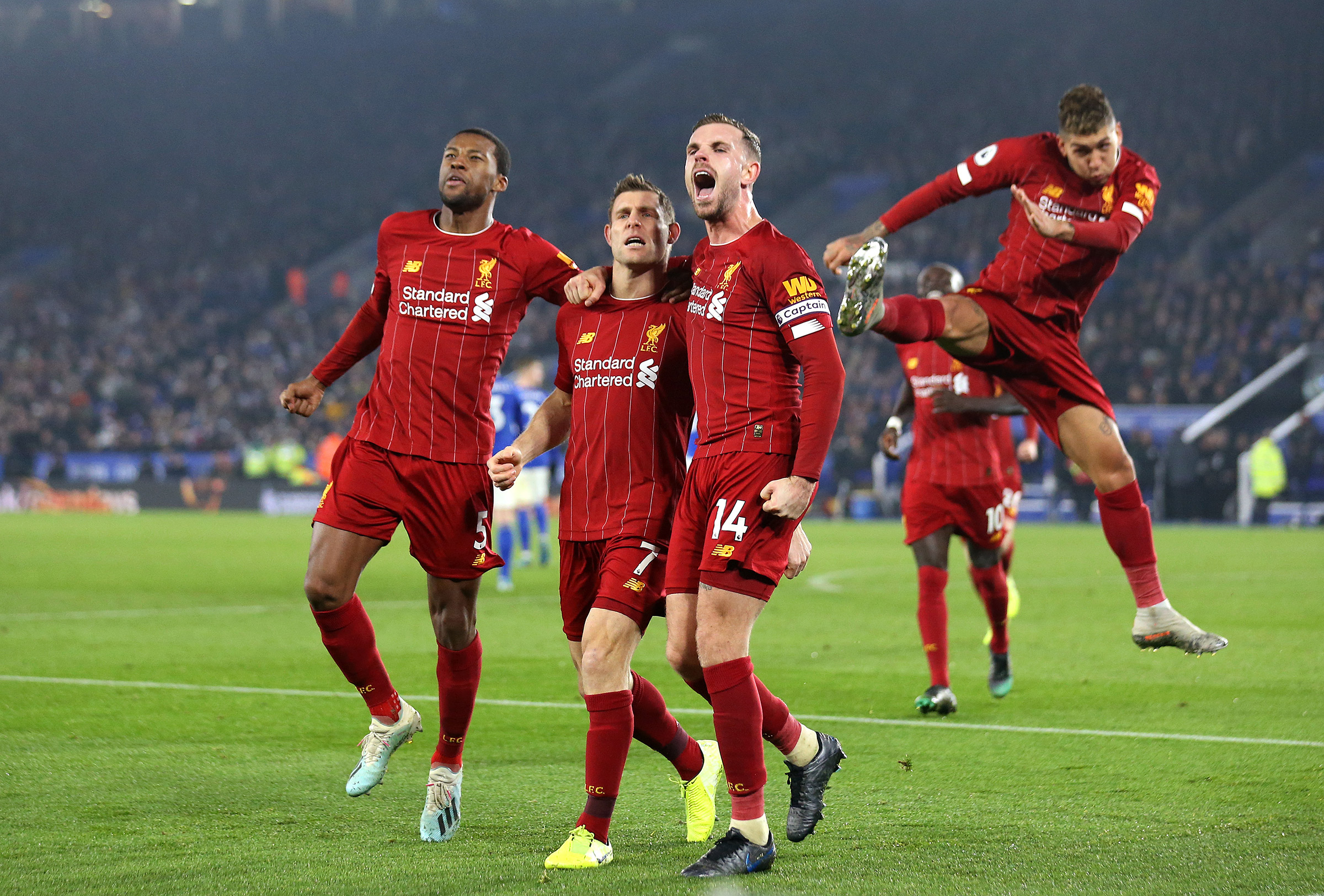 James Milner of Liverpool celebrates with Jordan Henderson and Georginio Wijnaldum during the Premier League match between Leicester City and Liverpool FC at The King Power Stadium in Leicester, United Kingdom on Dec. 26, 2019. (Getty Images)
