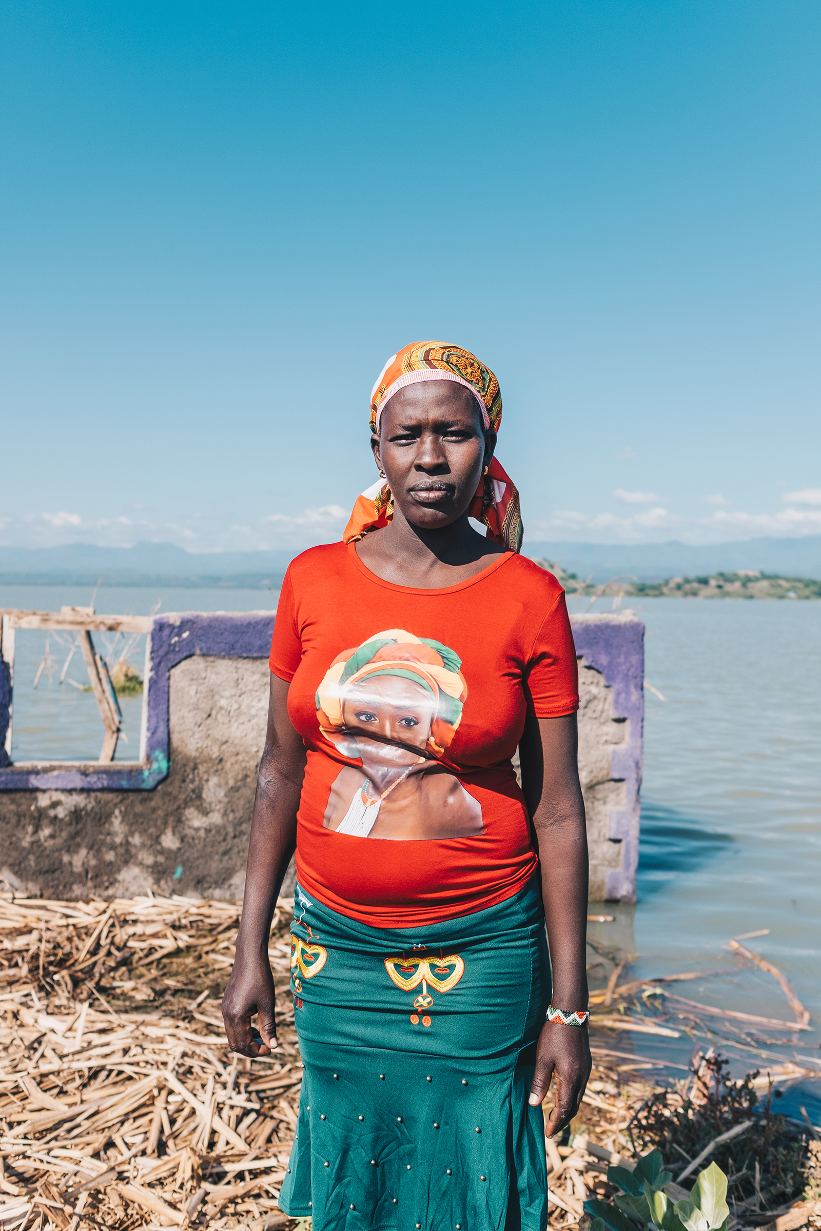 Judy Lewiri stands next to her former home on Ol Kokwe, an island within Lake Baringo, in November. She was forced to move to higher ground and rebuild on borrowed land.