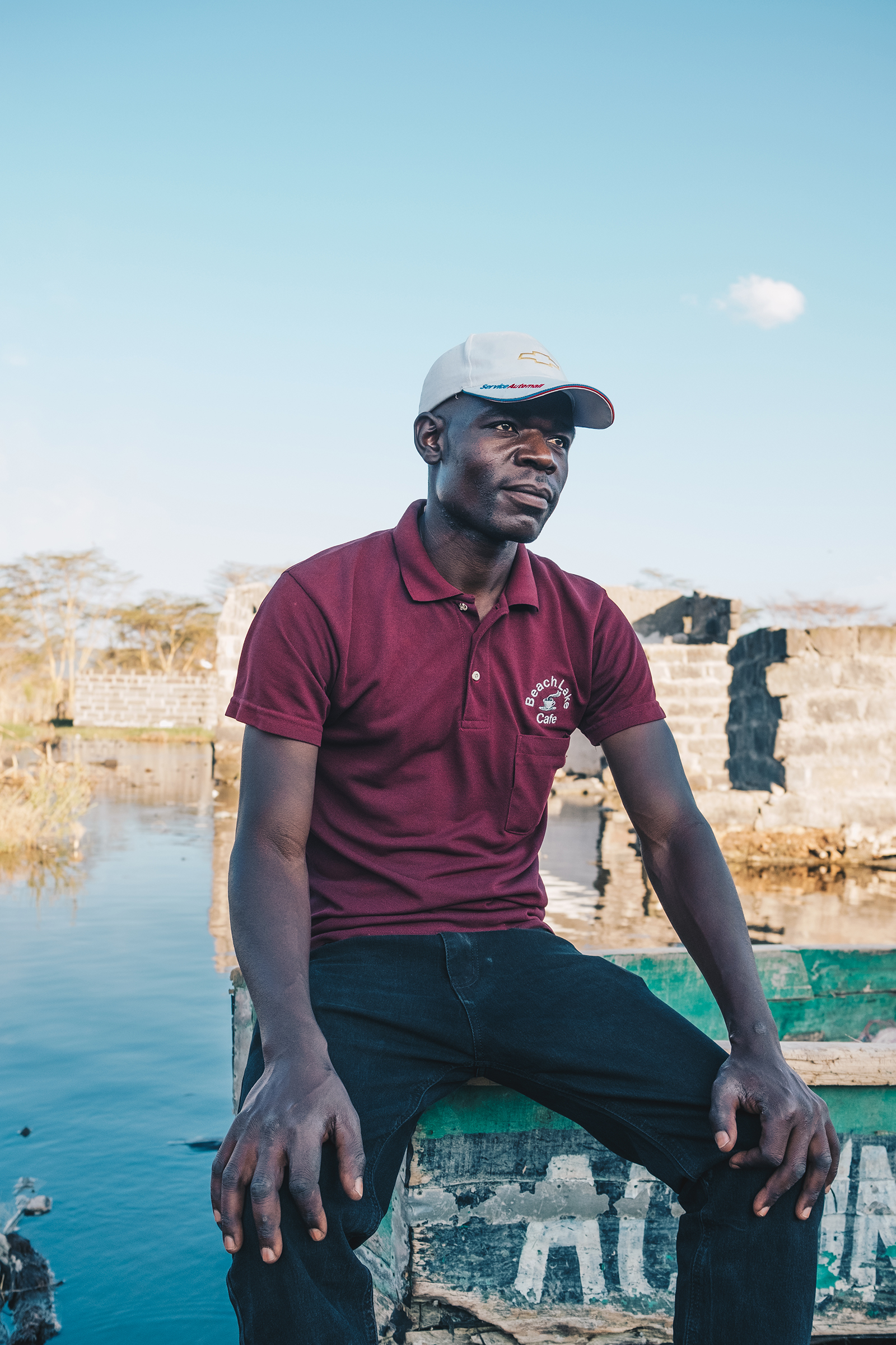 Gerrard Otieno sits on a boat in what used to be his living room in November. He is among hundreds of people displaced by Lake Nakuru's rising waters.