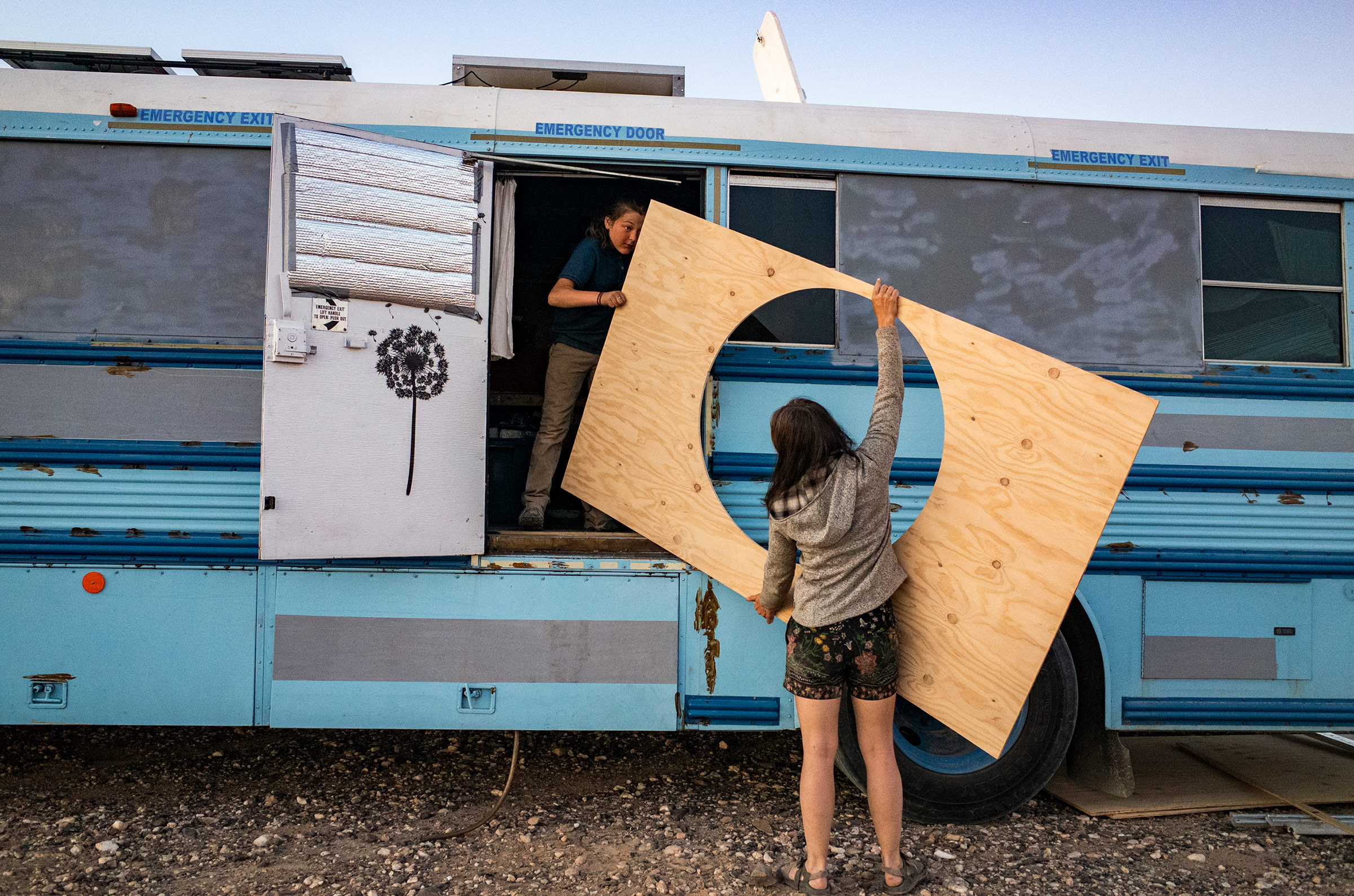 Paula and Max carry in a piece of wood to mount around Max’s "hobbit bed" on the school bus, outside Ehrenberg, Az., on Feb. 8. (Nina Riggio for TIME)