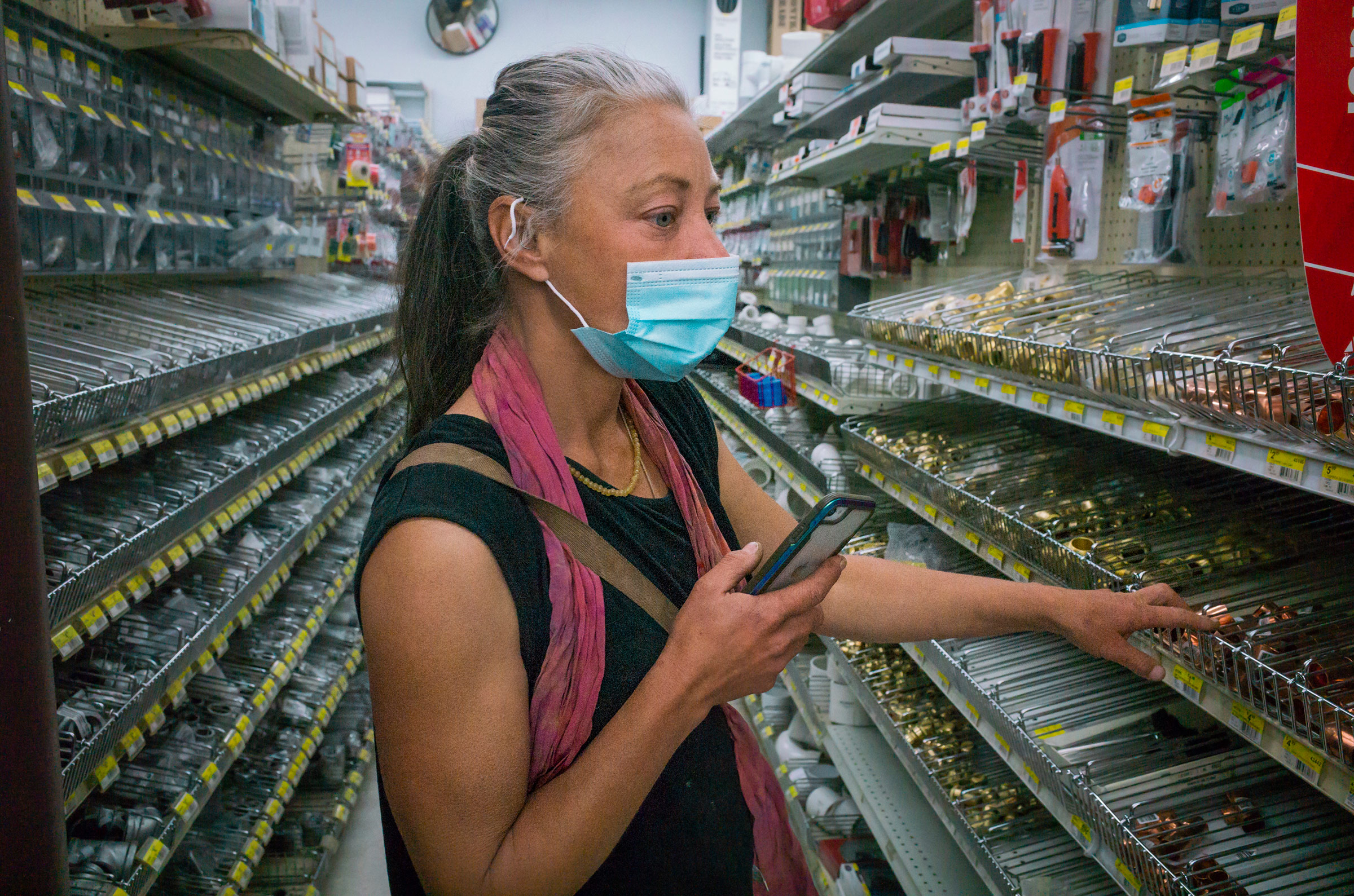 Paula looks for parts for a heater in a local hardware store on March 3. (Nina Riggio for TIME)