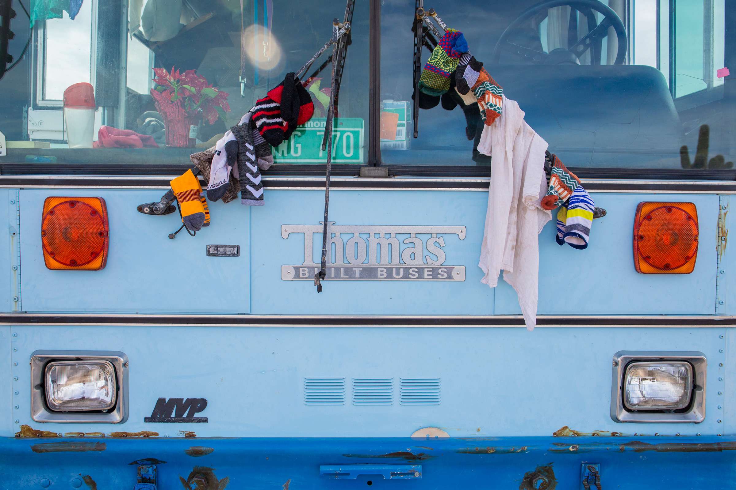 Paula and Max hang laundry on the bus to dry. (Nina Riggio for TIME)