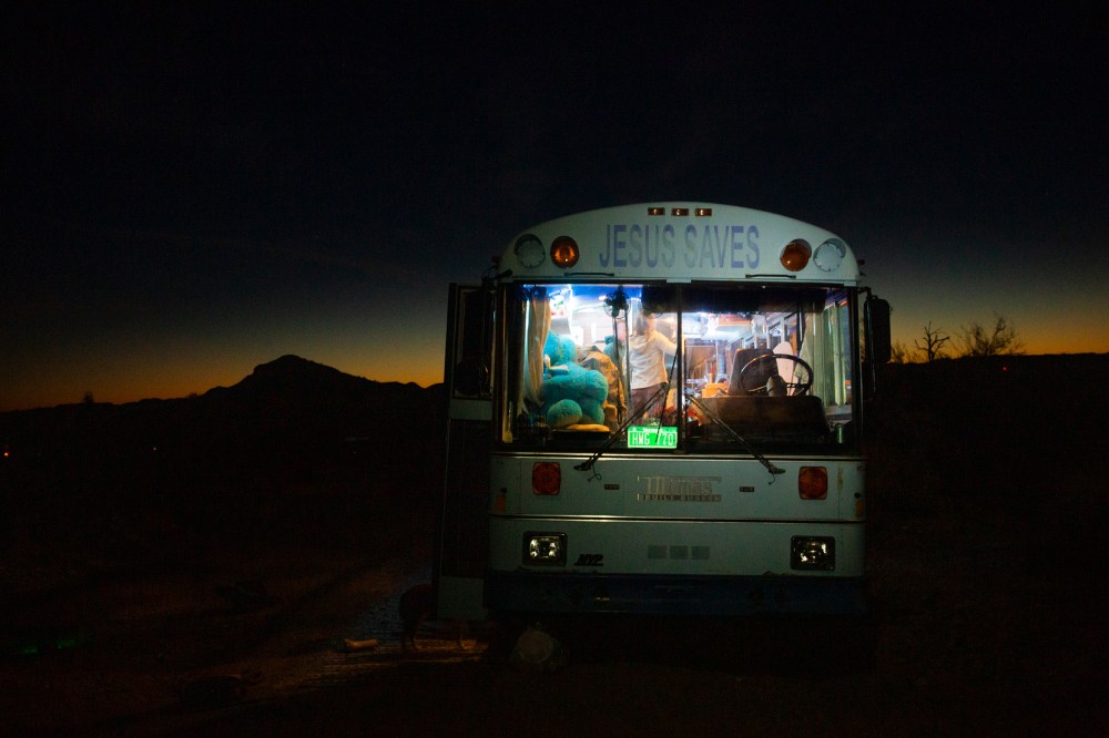 Paula and Maxâ€™s â€˜Jesus Savesâ€™ bus provides warmth on cold desert nights outside Lake Havasu City, Az., on Feb. 23. Paula was raised Jewish and does not identify as Christian; she found the retired Baptist school bus in San Diego last year and it fit within her budget. 