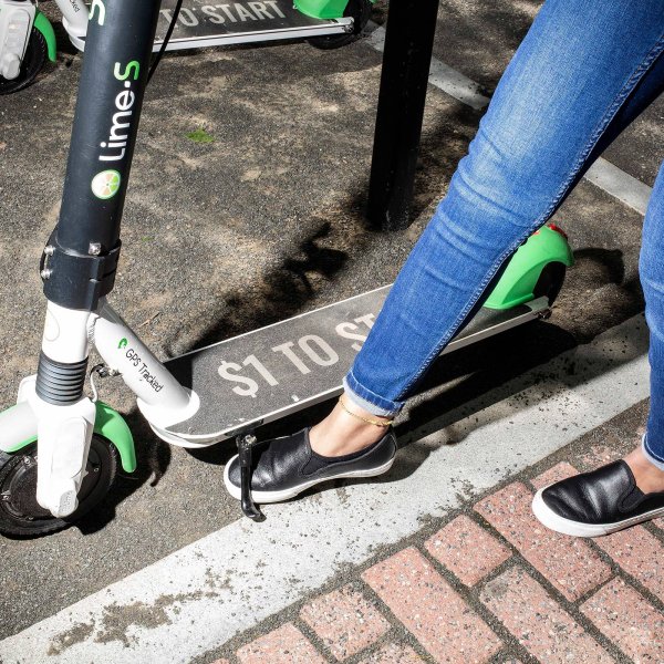 A woman prepares to ride a Lime scooter in Hoboken, N.J. on May 24, 2019.