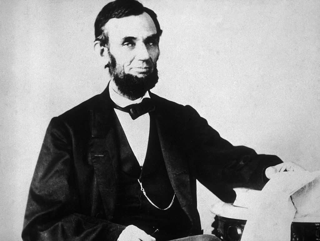 The 16th American president, Abraham Lincoln (1809 - 1865), sitting and leafing through documents, Washington, D.C. (Getty Images)