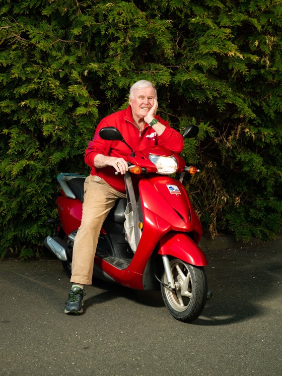 Jim Byrne poses for a portrait with his scooter outside of his home in Connecticut.