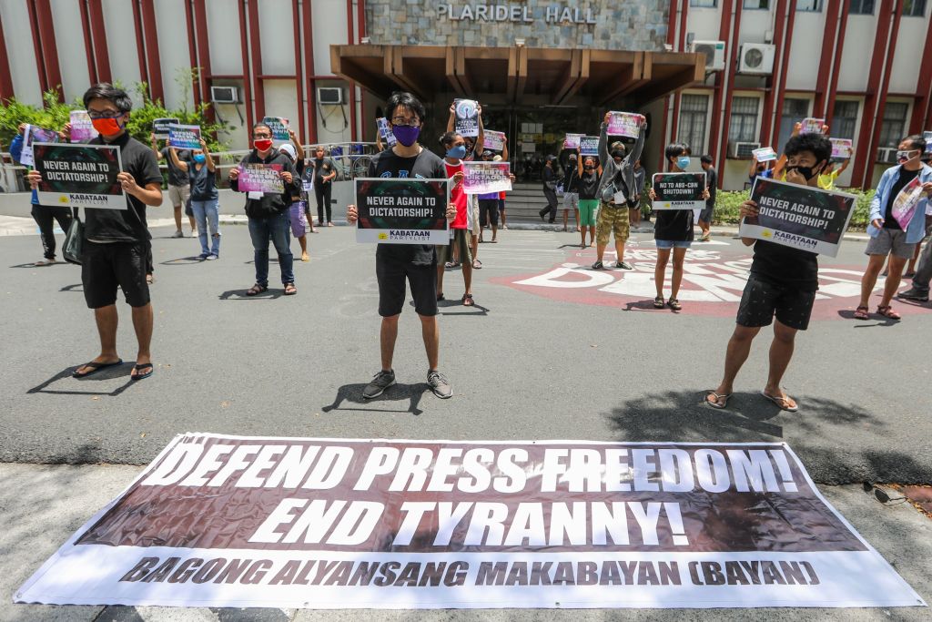 People from Bagong Alyansang Makabayan (Bayan) take part in a protest against the Philippine government-ordered shutdown of broadcaster ABS-CBN while observing social distancing outside the College of Mass Communication at the University of the Philippines in Manila on May 8, 2020. (Maria Tan—AFP/Getty Images)