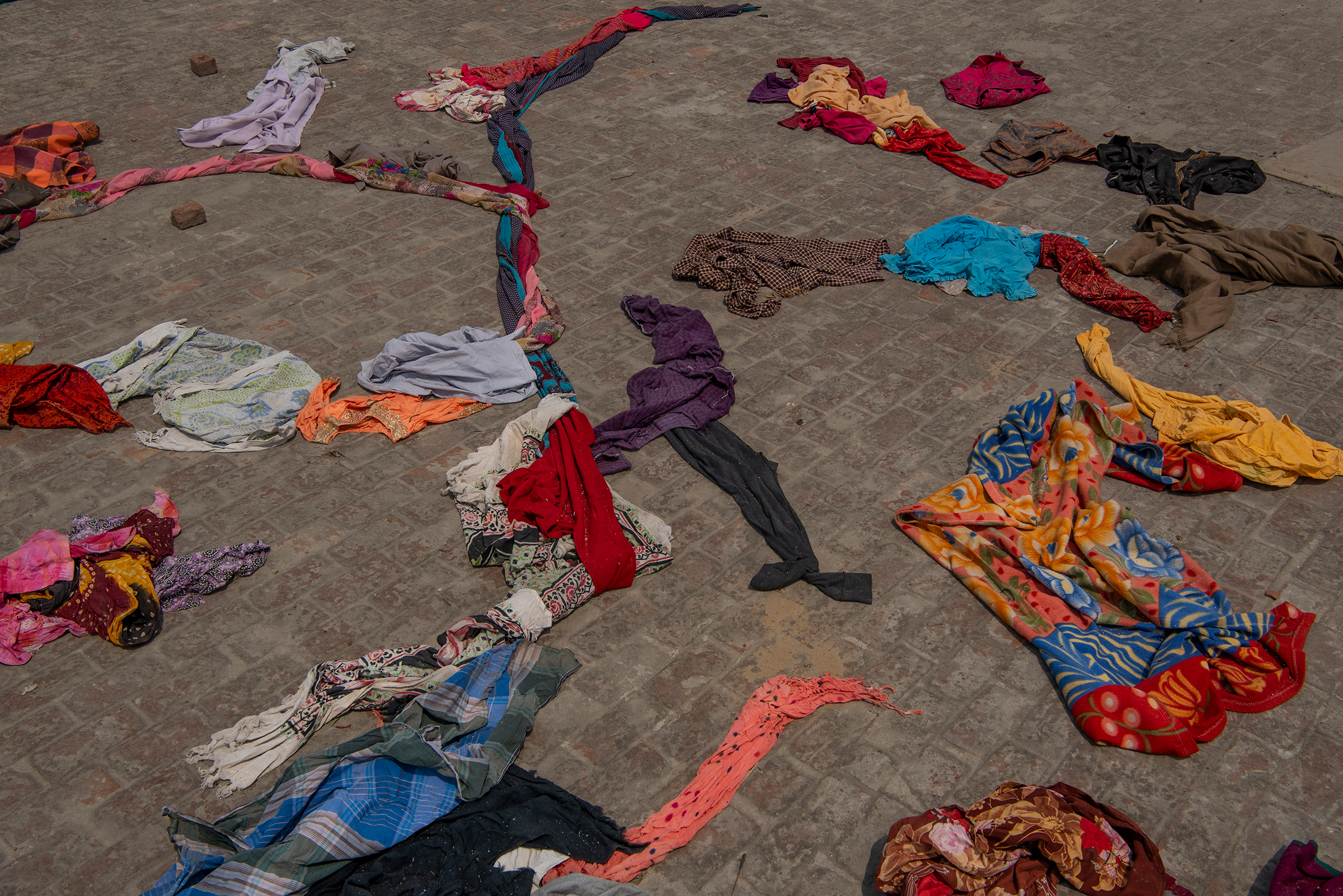 Clothes of the deceased lie on a terrace of a building within the crematorium premises in New Delhi on April 27.