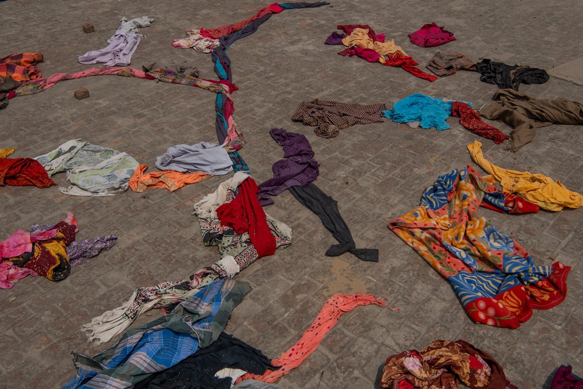 Clothes of the deceased lie on the terrace of a building within crematorium premises in New Delhi on April 27.