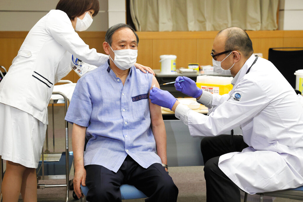 Japanese Prime Minister Yoshihide Suga receives his first dose of Pfizer's COVID-19 vaccine at National Center for Global Health and Medicine in Tokyo on March 16, 2021. (Kyodo News/AP Images)