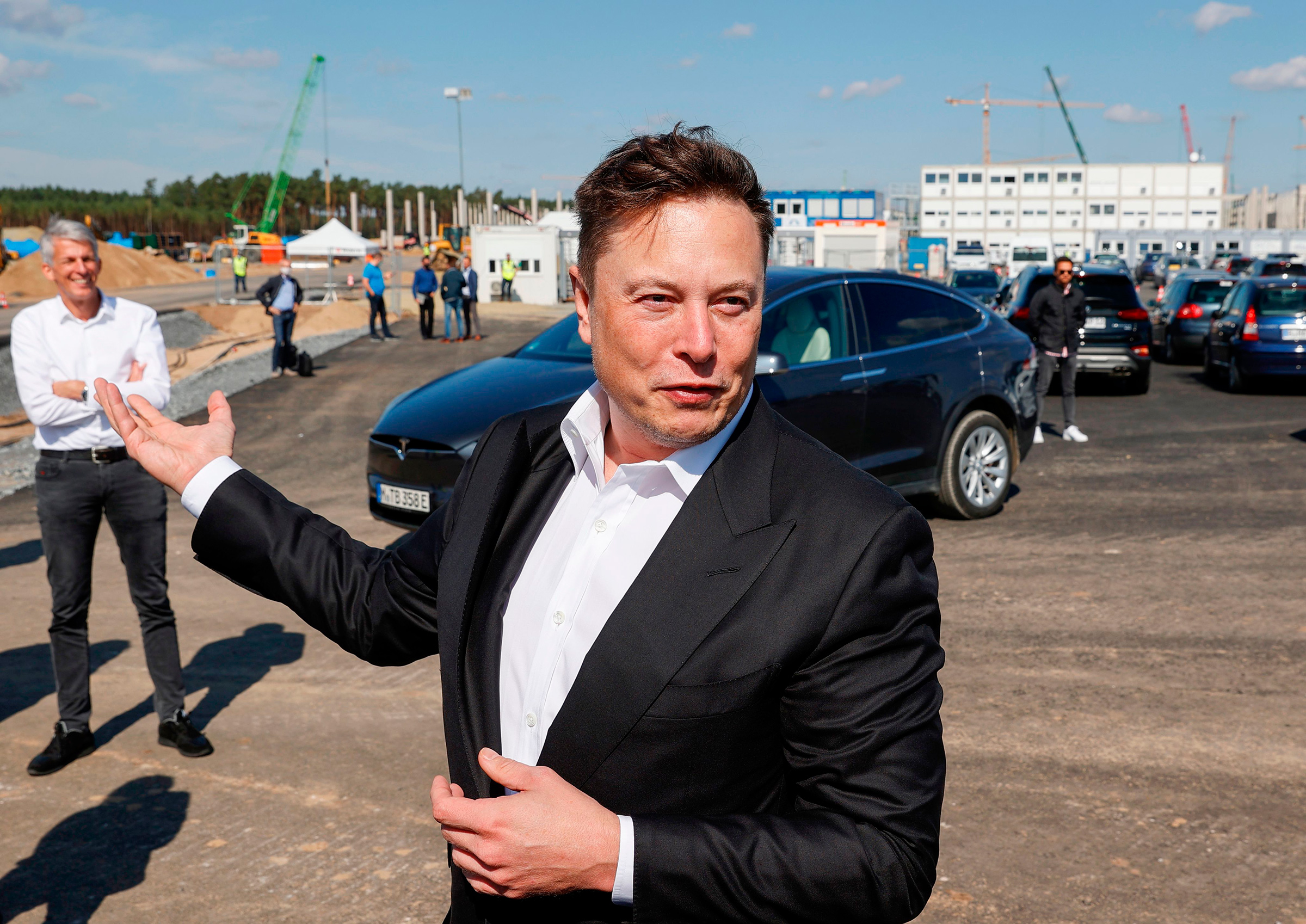 Tesla CEO Elon Musk talks to media as he arrives at a construction site in September, 2020. (Odd Andersen—AFP/Getty Images)