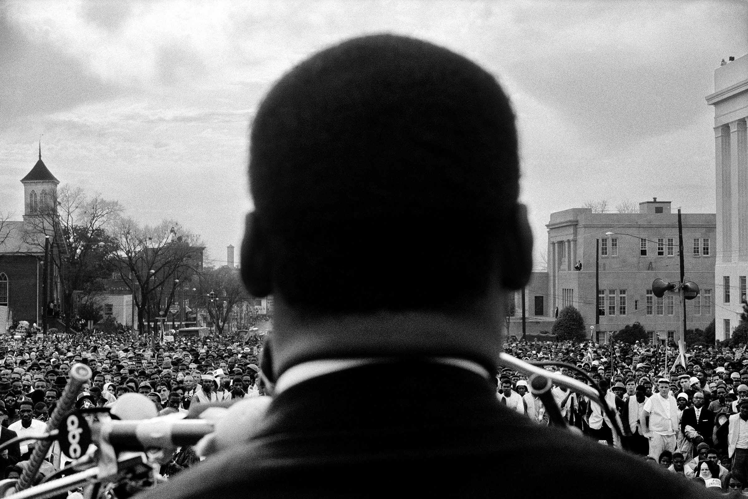 Dr. Martin Luther King, Jr. seen close from the rear, speaking to 25,000 civil rights marchers in front of the Alabama state capital building, at the conclusion of the Selma to Montgomery march, Montgomery, Alabama, March 25, 1965. (Stephen Somerstein—Getty Images)