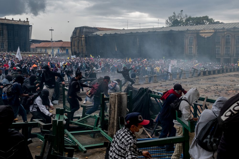 Protesters run up against barricades in Bogotá on April 28.
