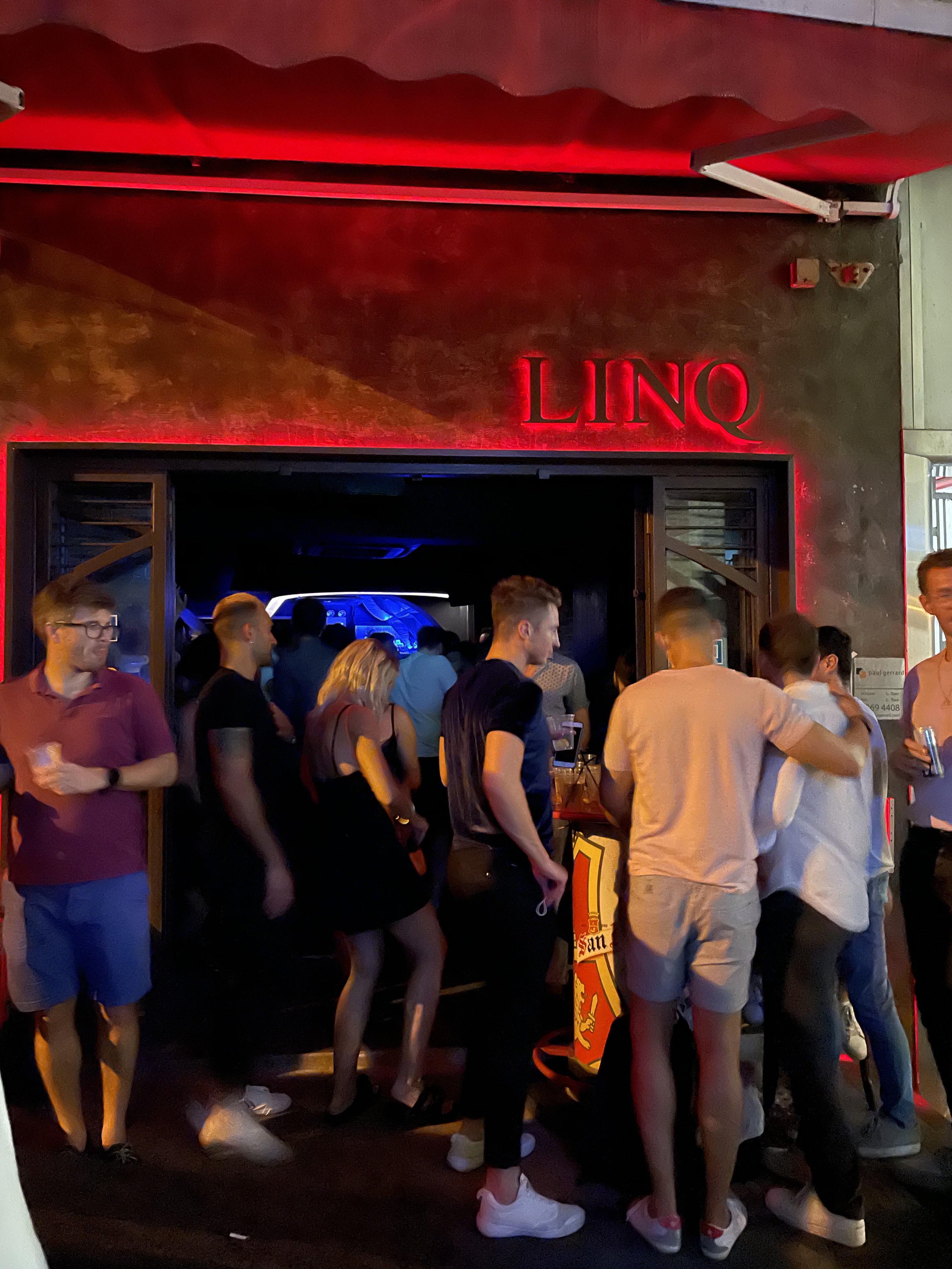 Patrons crowd outside Linq Bar in Hong Kong's Central district on April 30, 2021—after it re-opened following 5 months closed due to COVID-19 restrictions. Hong Kong's new rules require bar visitors and staff to be vaccinated. (Amy Gunia–TIME)