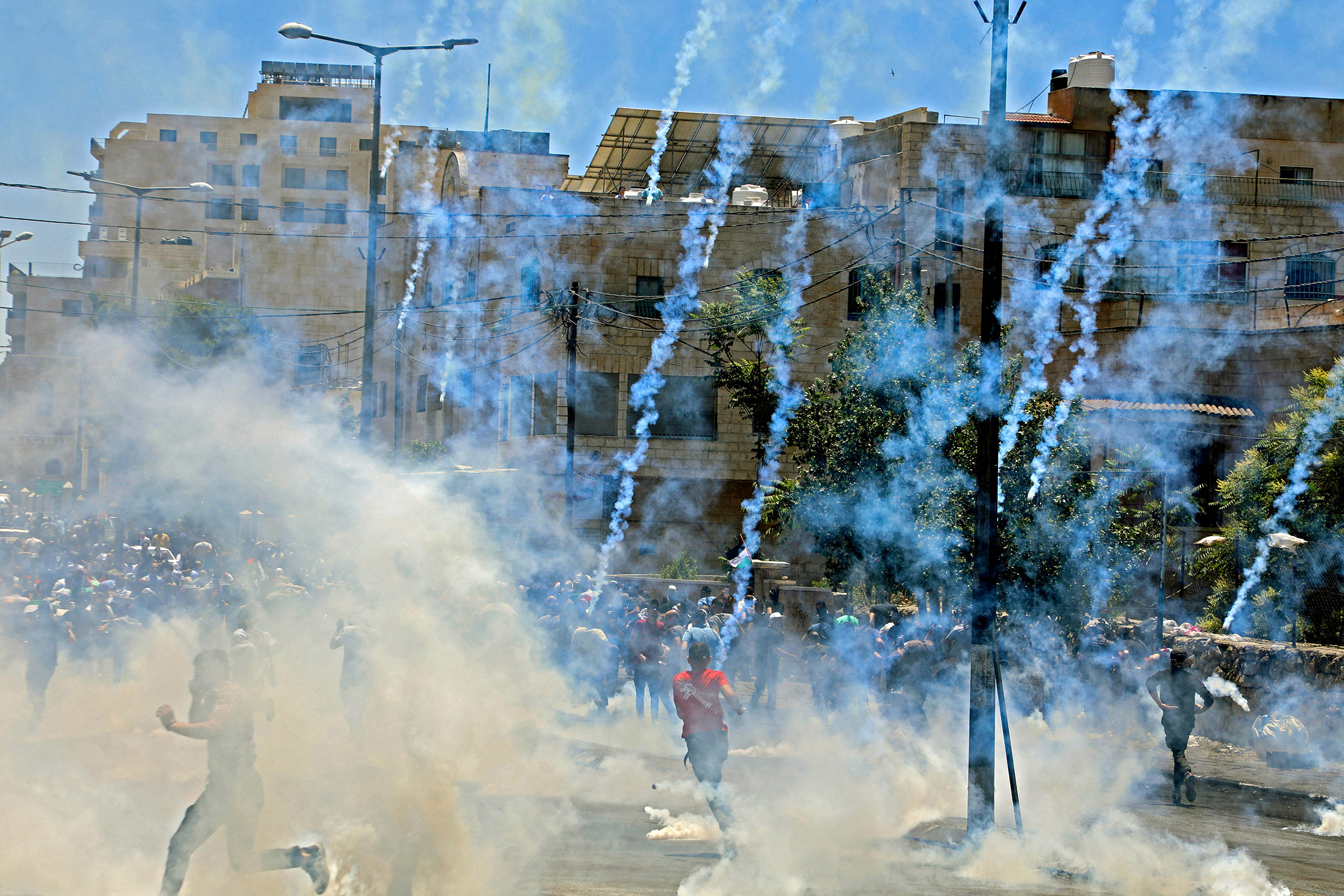 Israeli troops fire tear gas towards demonstrators during a protest against Israeli occupation in the West Bank on May 18. (AFP/Getty Images)