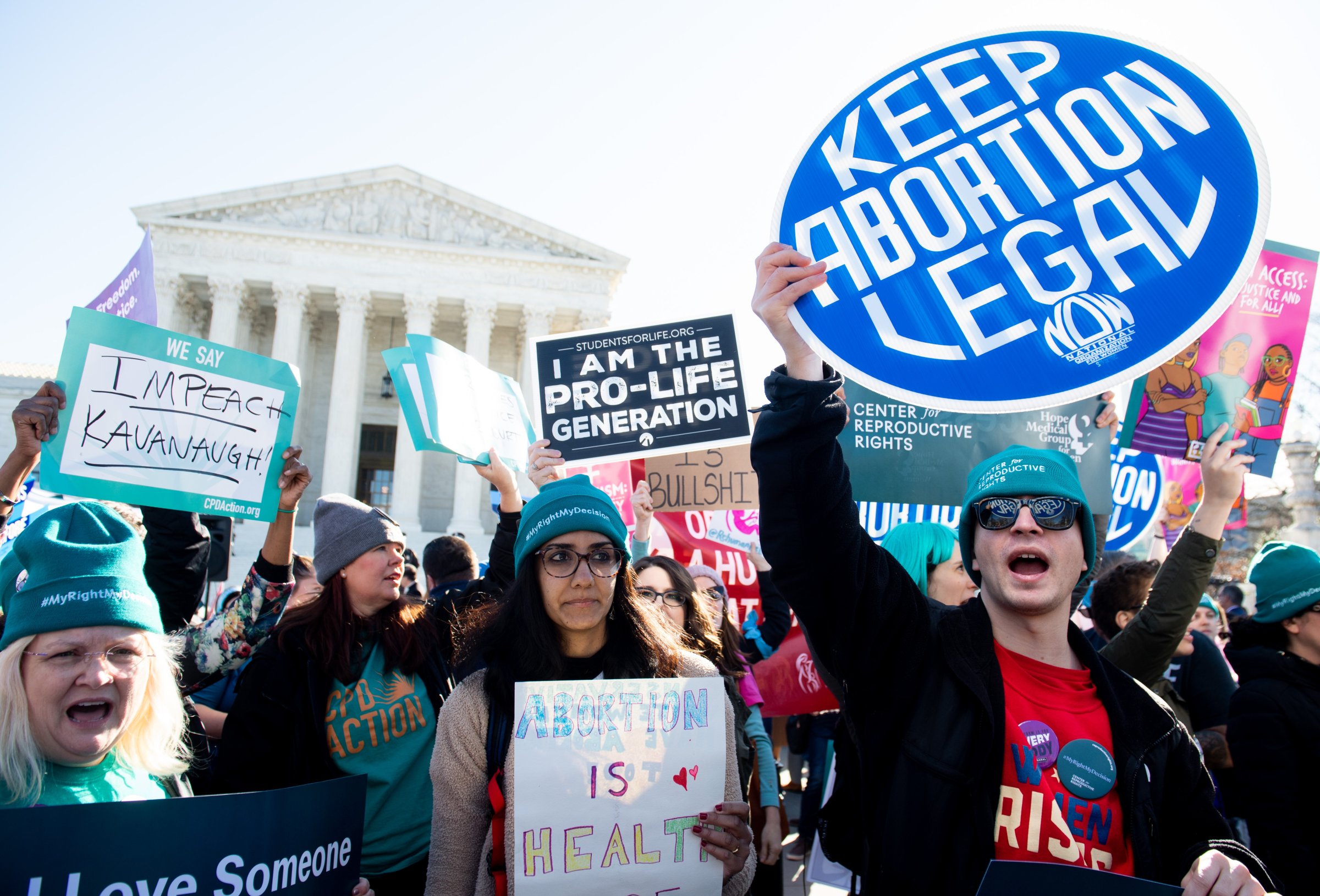 Abortion rights activists and those opposing abortion protest during a demonstration outside the U.S. Supreme Court in Washington, D.C., March 4, 2020, during oral arguments regarding a Louisiana law about abortion access.
