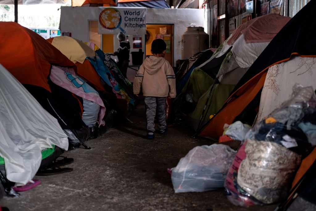 A migrant boy walks amid tents at the Juventud 2000 migrant shelter in Tijuana, Mexico, on December 17, 2020. (Guillermo Arias—AFP/Getty Images)