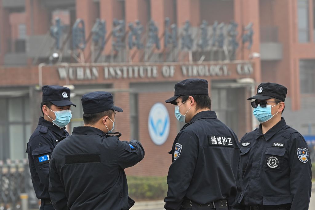 Security personnel stand guard outside the Wuhan Institute of Virology in Wuhan as members of the World Health Organization (WHO) team investigating the origins of the COVID-19 coronavirus make a visit to the institute in Wuhan in China's central Hubei province on Feb. 3, 2021. (Hector Retamal–AFP/Getty Images)