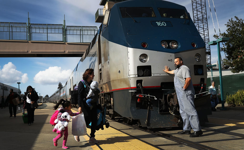 An Amtrak engineer leans on the locomotive as passengers disembark from Amtrak's California Zephyr at the end of its daily 2,438-mile trip to Emeryville/San Francisco from Chicago that took roughly 52 hours on March 25, 2017 in Emeryville, California. (Joe Raedle—Getty Images)