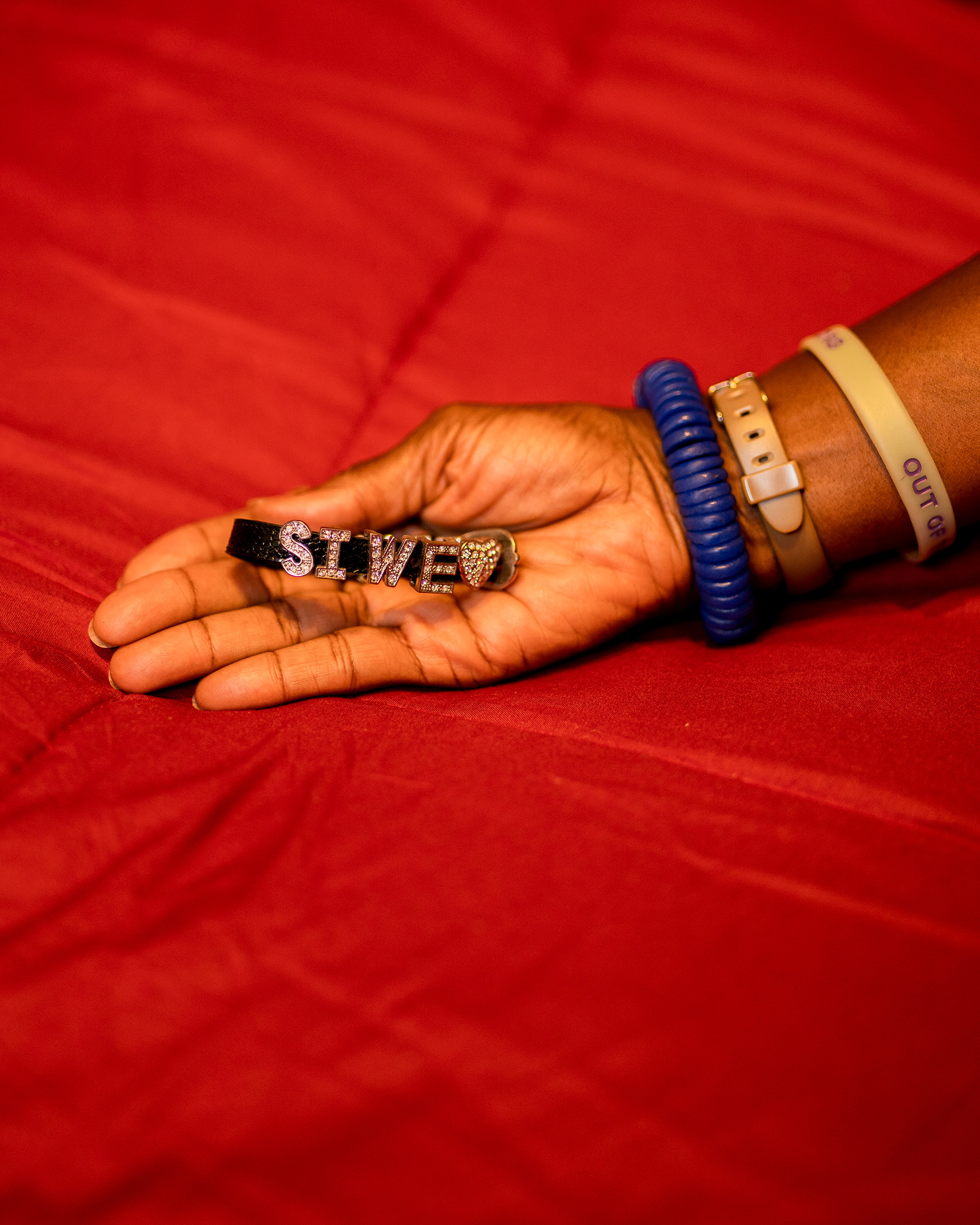 Dionne Monsanto holds a bracelet that Siwe made. “With a name like Busisiwe Ayo Monsanto...she could never buy anything pre-made with her name. So it was a big deal that there was a place that she could do that,” Monsanto says.