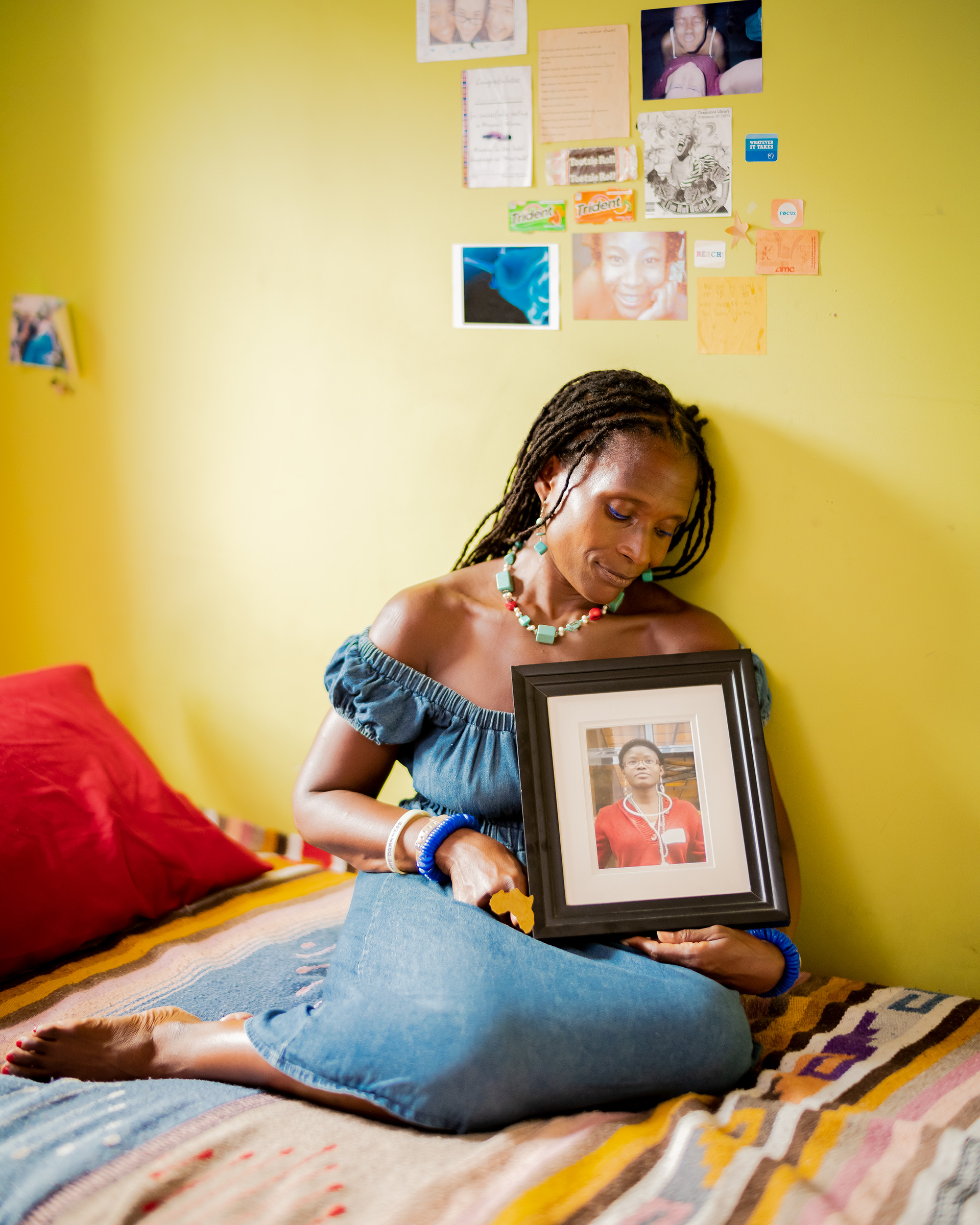 Dionne Monsanto holds a portrait of her daughter, Siwe, in the girl's bedroom in New York City, on Sept. 9, 2020. Siwe, 15, died by suicide in 2011.