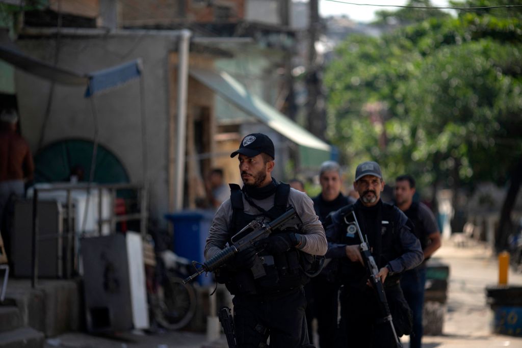 Civil Police officers take part in an operation against alleged drug traffickers at the Jacarezinho favela in Rio de Janeiro, Brazil, on May 06, 2021. (Photo by MAURO PIMENTEL / AFP)
