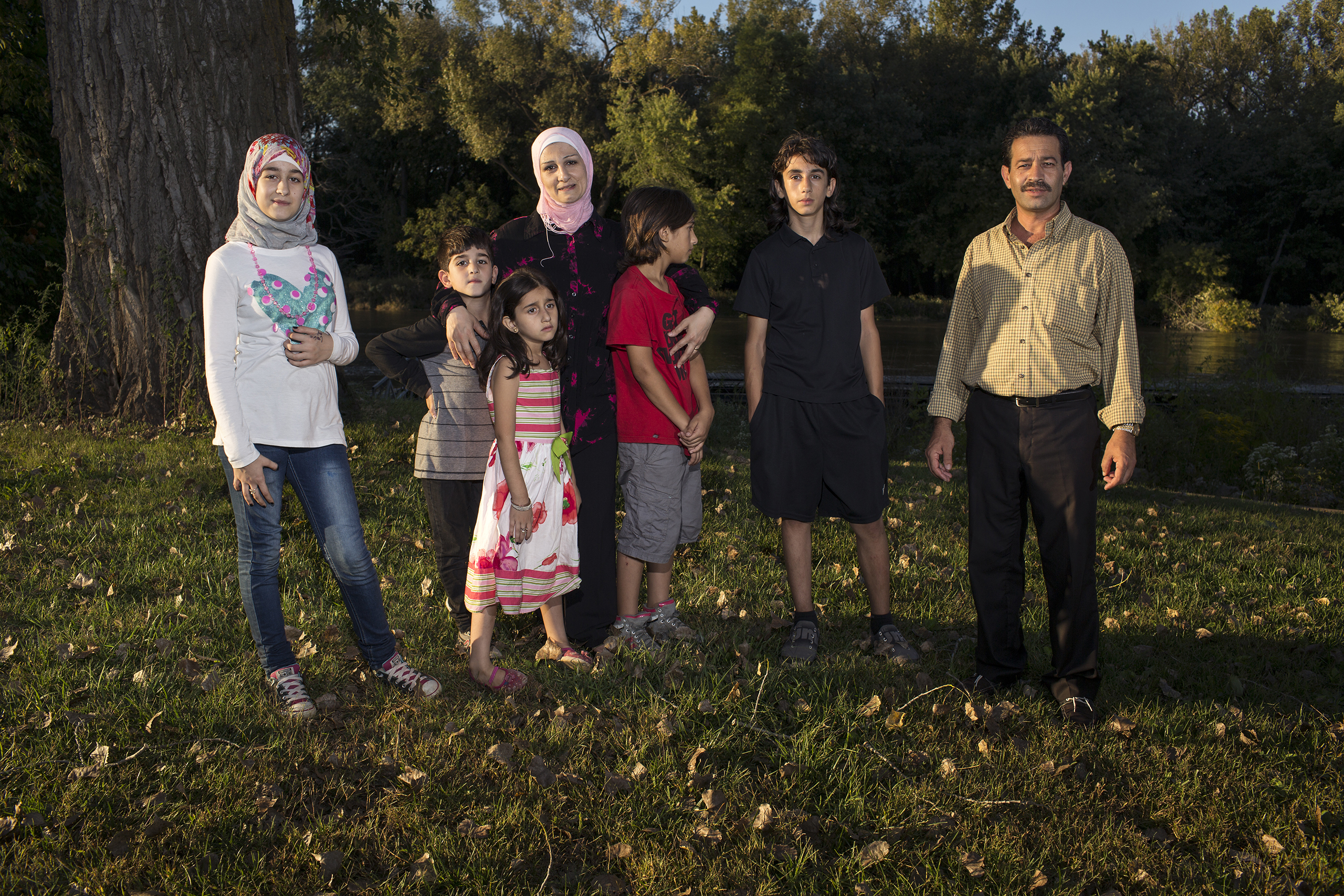 Ghazweh and Abdul Fattah at a park in Des Moines in 2016 with their children, from left to right: Sedra, Mutaz, Hala, Haidar and Nazeer. That year, the Tameems became the first Syrian refugee family to be resettled in Iowa. In the four decades of the U.S. refugee resettlement program, America has safely resettled more than three million of the world’s most vulnerable refugees with an average annual cap set at 95,000 prior to the Trump administration. (Danny Wilcox Frazier—VII for TIME)