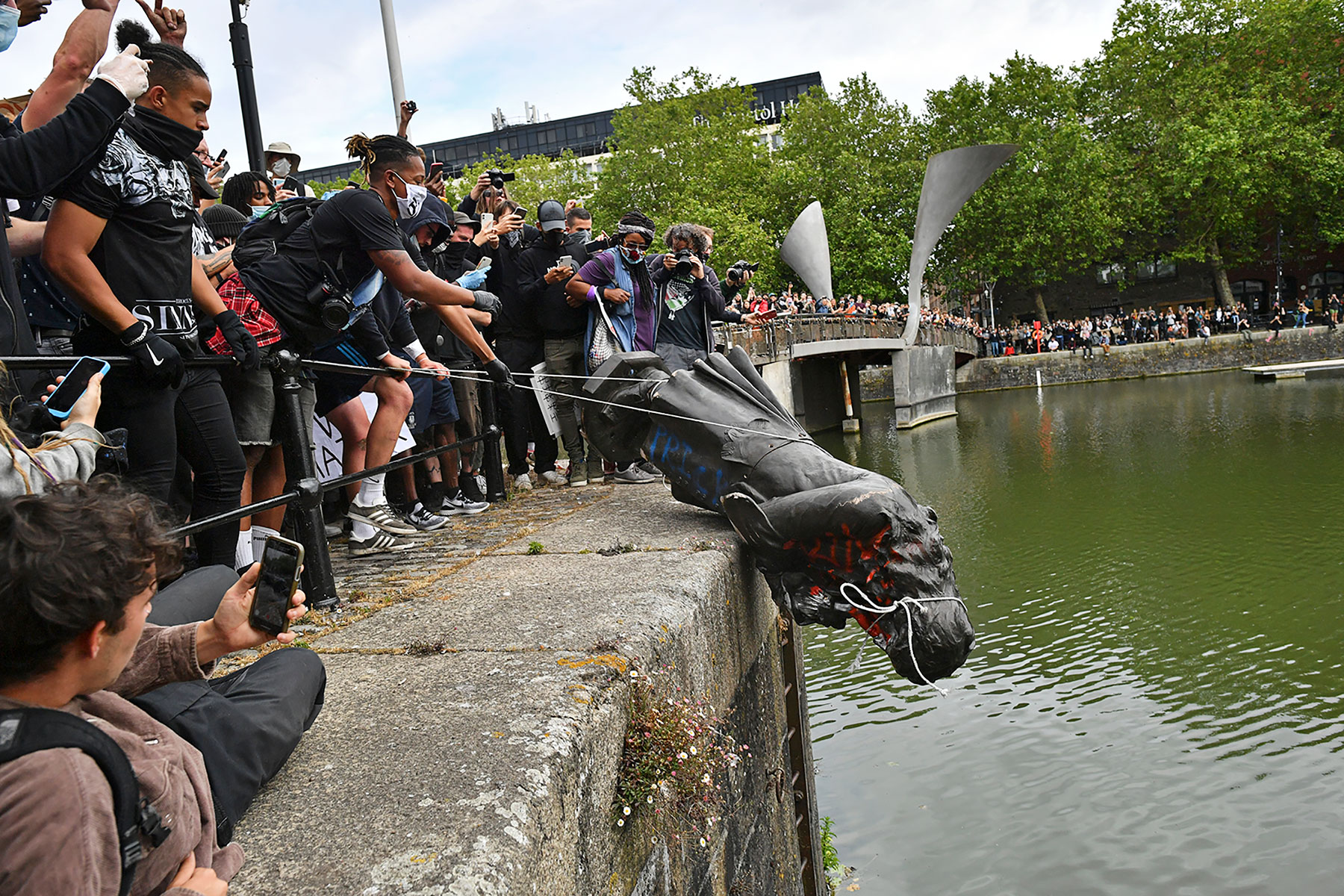 The statue of Edward Colston is thrown into the harbor of Bristol in southwest England, June 7, 2020. (Ben Birchall—PA Wire/AP)