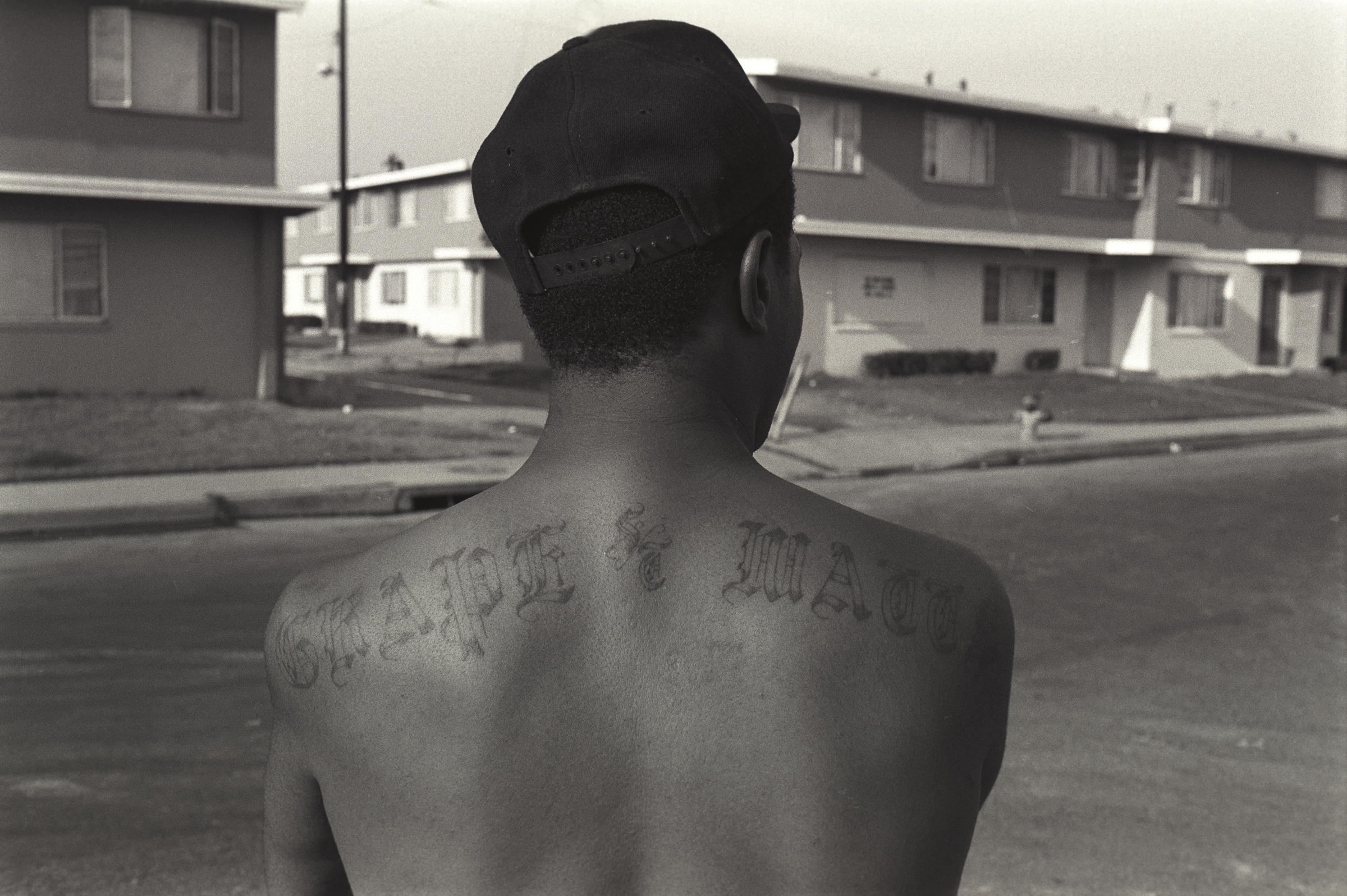 An OG, or "original gangster," member of the Grape Street Crips shows off his tattoo.