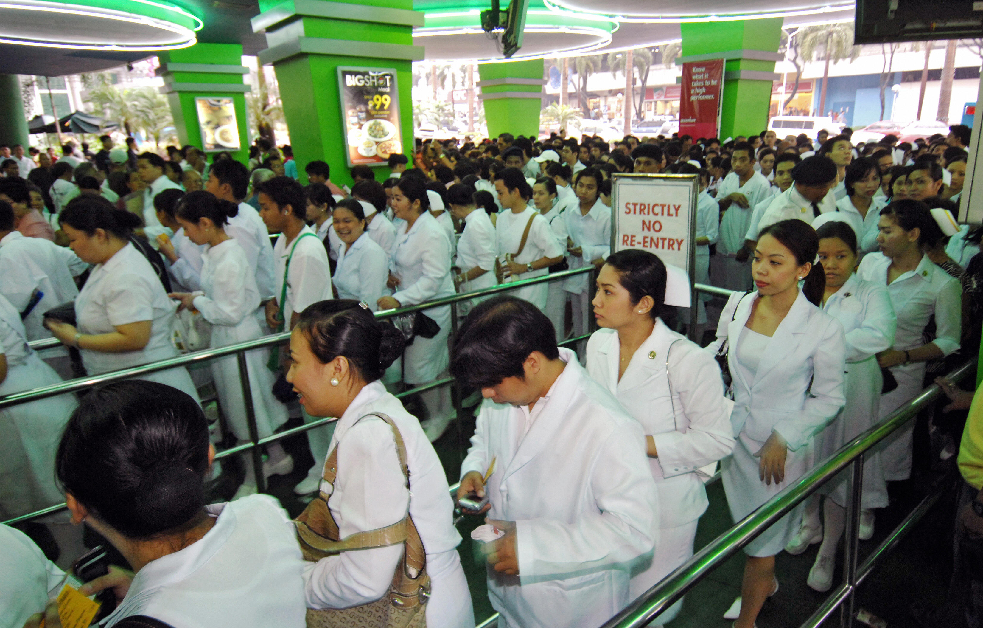 Hundreds of nurses arrive at the Araneta coliseum in Manila, 02 October 2007 to attend official oath taking ceremonies after passing the June 2007 government licensure examination, where 31,275 successful examinees from the more than 64,000 passed the tests conducted nationwide. (ROMEO GACAD—AFP/Getty Images)