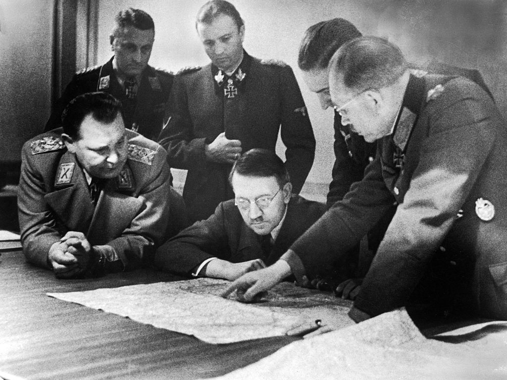 Adolf Hitler (center, in glasses) and members of his General Staff review plans for 'Operation Bodenplatte' (also known as 'the Great Blow'), an airstrike in support of the Ardennes offensive, late 1944. (Heinrich Hoffman/The LIFE Picture Collection—Getty Images)