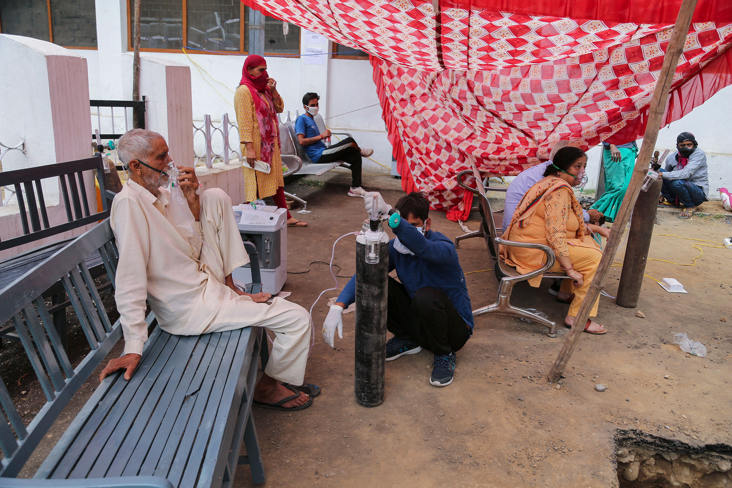 COVID-19 patients receive oxygen outside a government run hospital in Jammu, India, on May 12, 2021. (Channi Anand—AP)