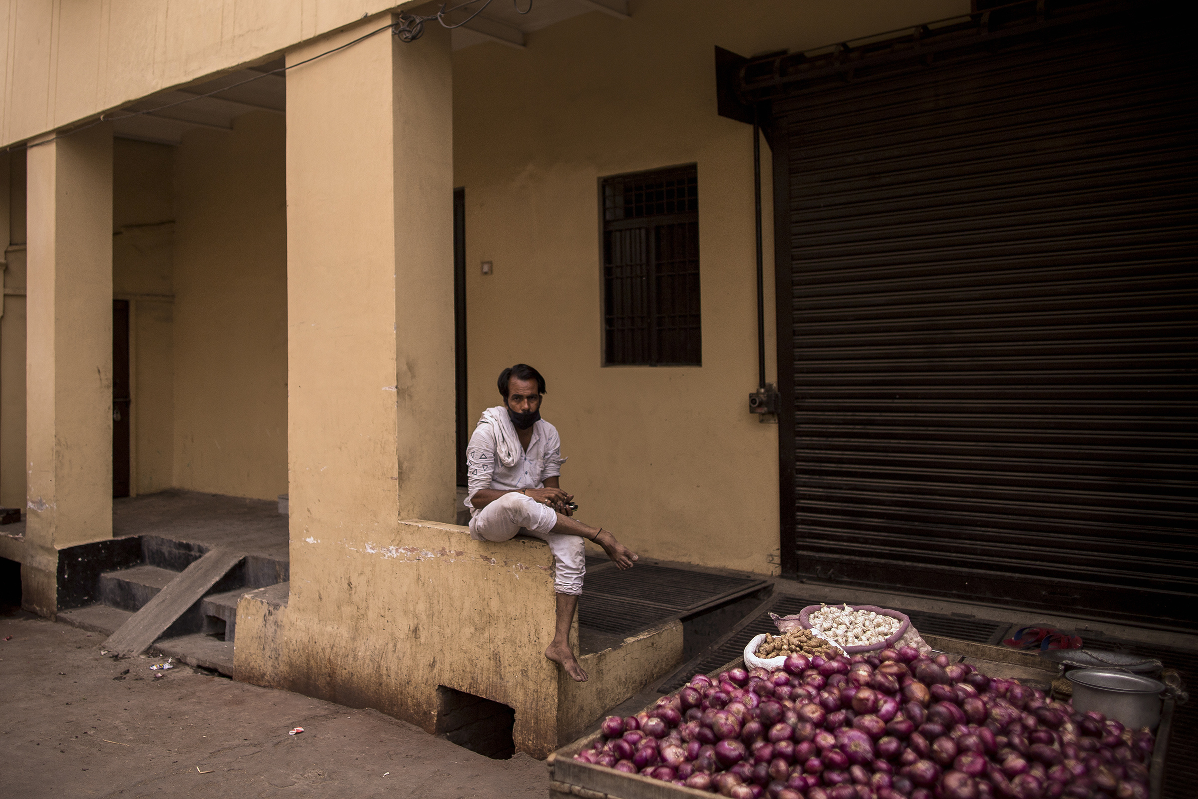 An onion vendor waits for customers on a deserted street during a lockdown in Agra, Uttar Pradesh, on May 3, 2021. (Anindito Mukherjee—Bloomberg/Getty Images)