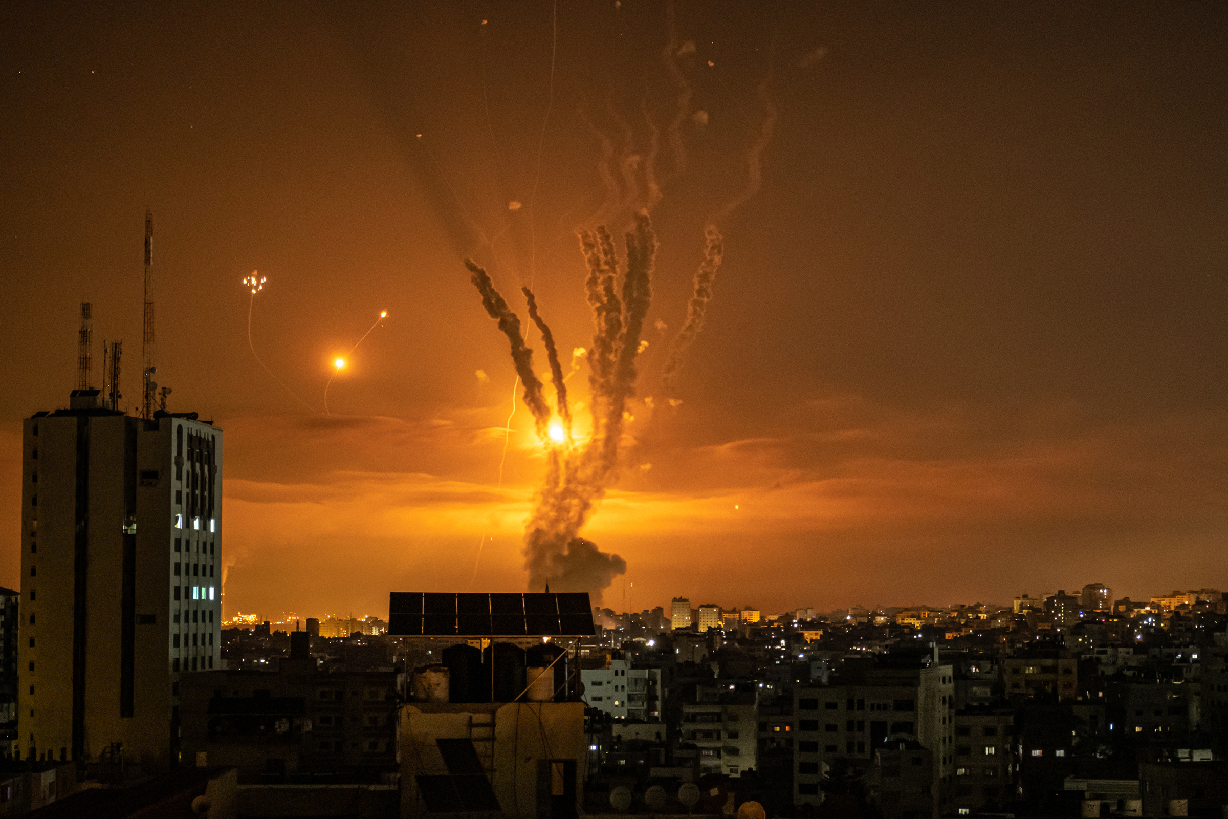 Rockets launched toward Israel from the northern Gaza Strip, and the response from the Israeli missile-defense system known as the Iron Dome, leave streaks through the sky in Gaza City on May 14. (Fatima Shbair—Getty Images)