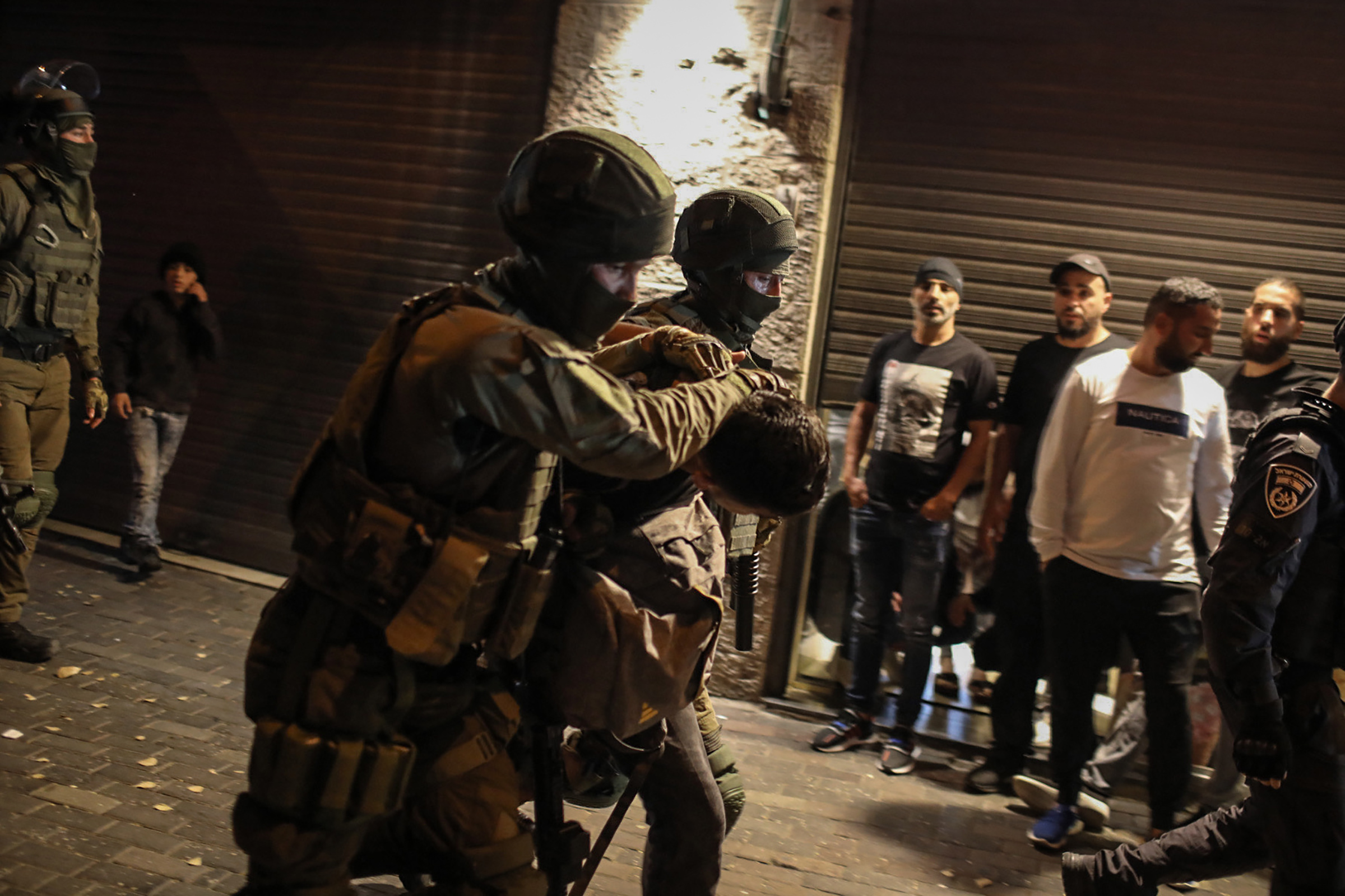 Israeli security forces arrest a man during a demonstration against the planned eviction process for the Palestinians in the Sheikh Jarrah neighbourhood of Jerusalem, on May 7, 2021.