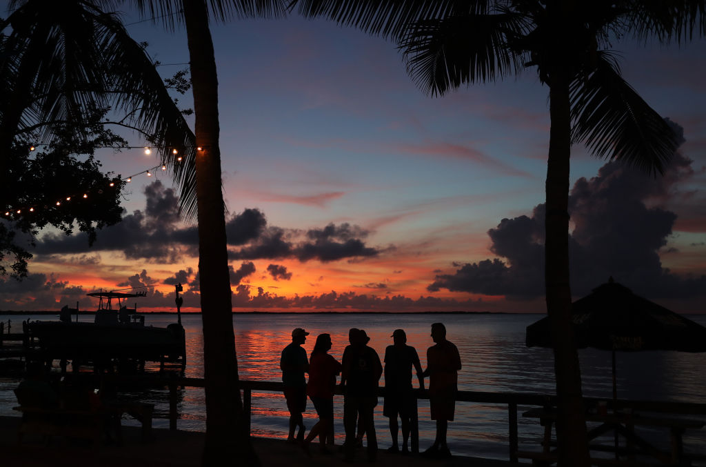 People enjoy the sunset over the water in the Gulf of Mexico during the seasonal king tides on October 27, 2019 in Key Largo, Florida. (Joe Raedle—Getty Images)