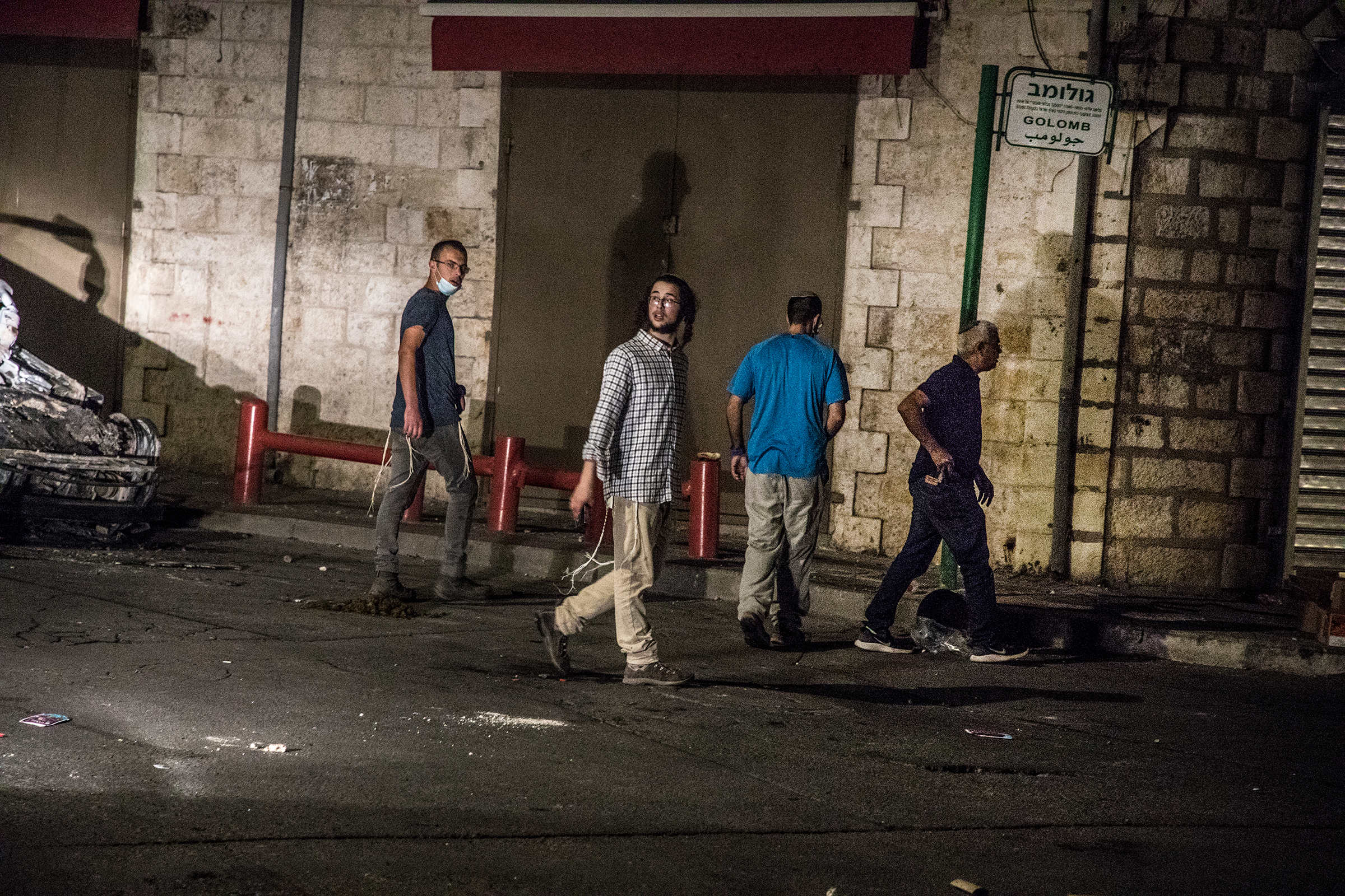Young Jewish men from a group comprising settlers and extreme right-wing activists, mostly armed, try to approach the downtown mosque in the mixed city of Lod, Israel, on May 12, 2021.