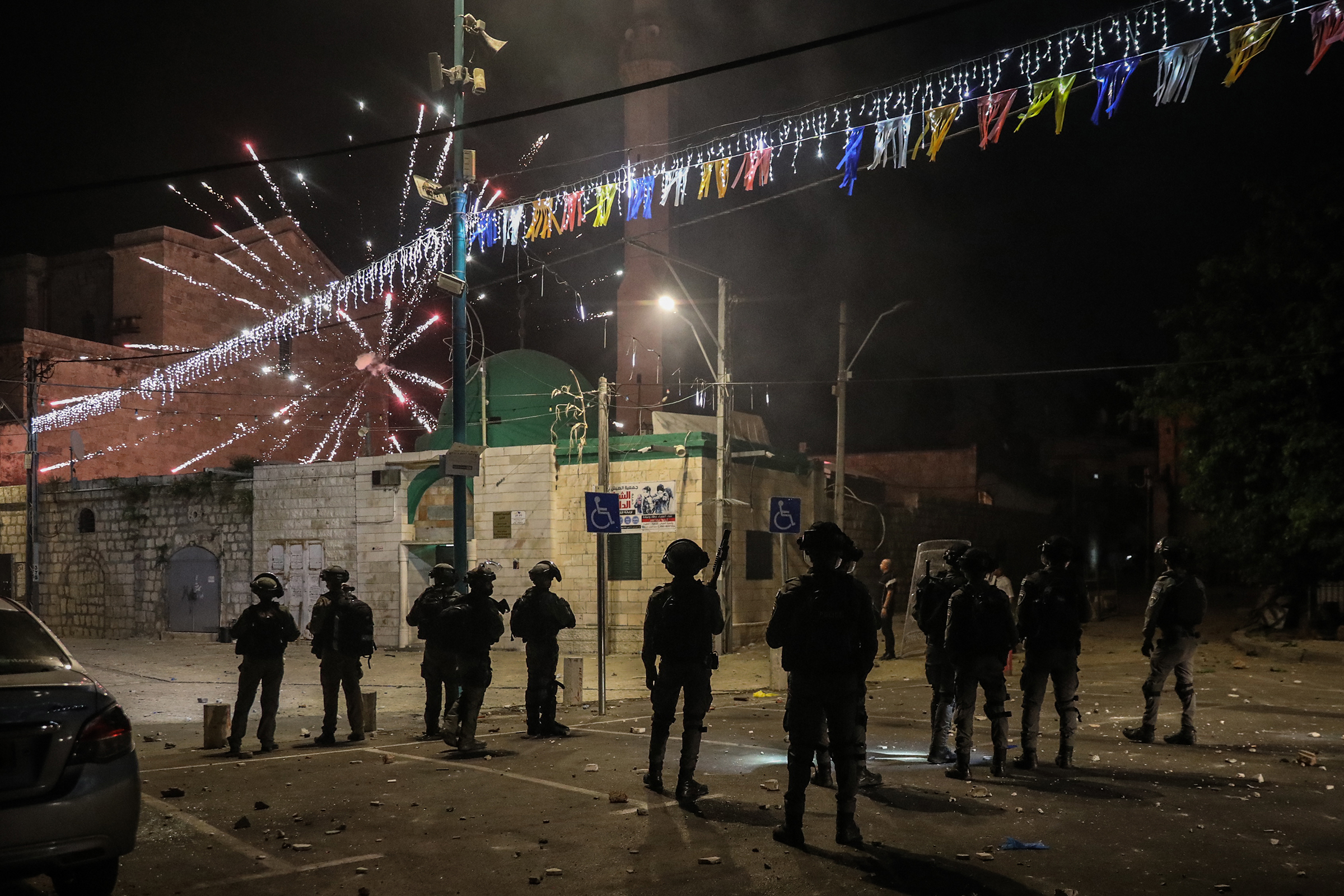 Fireworks are released towards Israeli soldiers during clashes amid a night-time curfew in the mixed Israeli-Arab city of Lod on May 12, 2021.