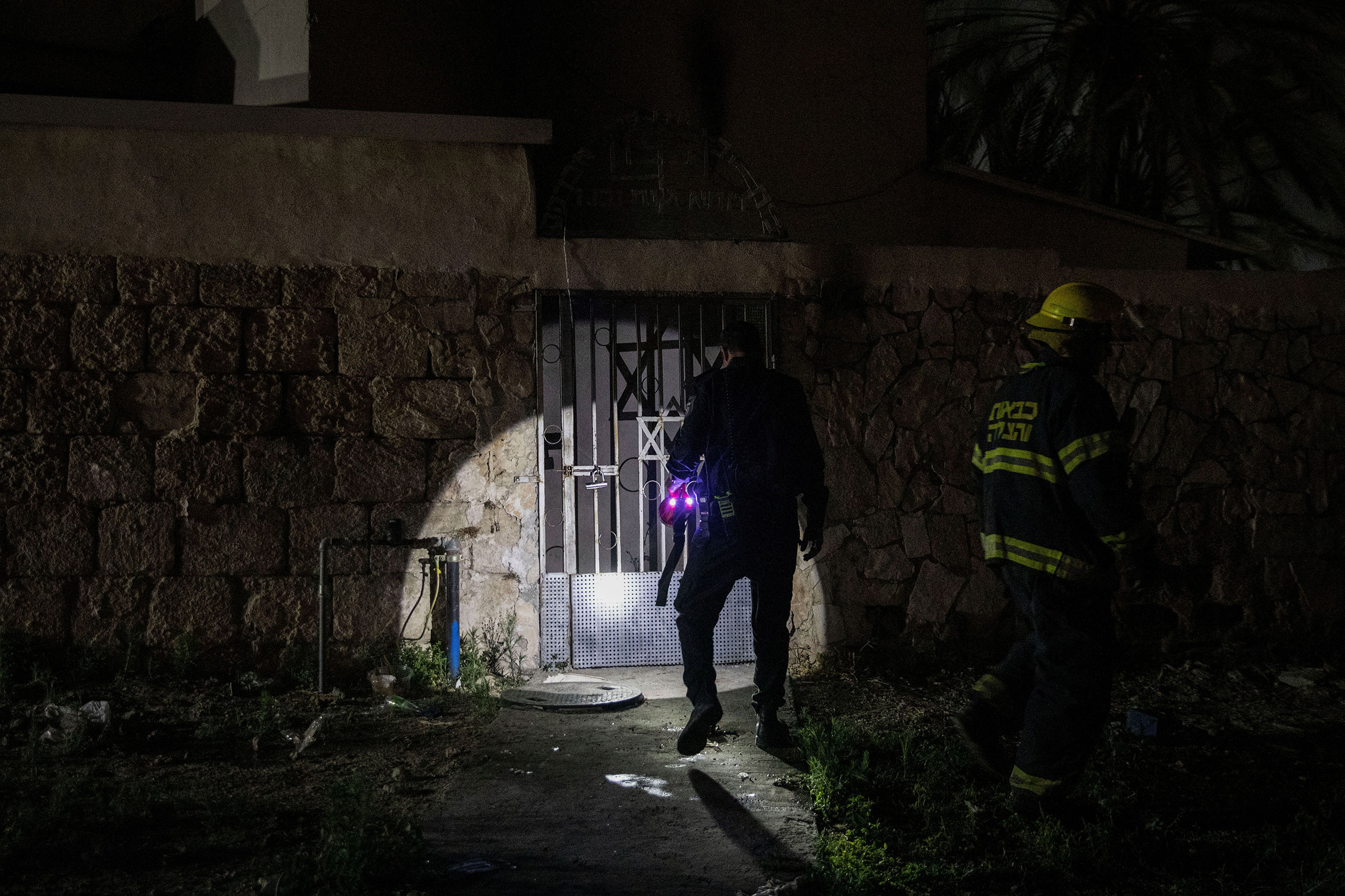 Firefighters inspect a synagogue that was set on fire during violent clashes in the mixed Arab-Jewish city of Lod, Israel, on May 14, 2021. (Oren Ziv—dpa/picture alliance/Getty Images)