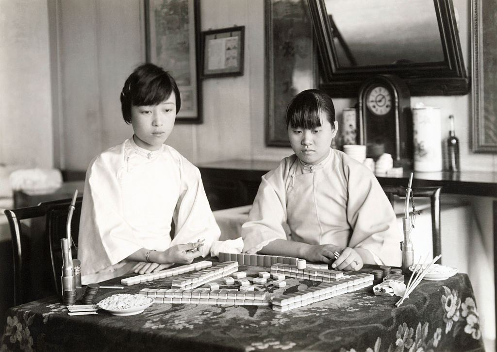 Two Chinese girls playing mah-jongg, circa 1920s (Bettmann Archive—Getty Images)