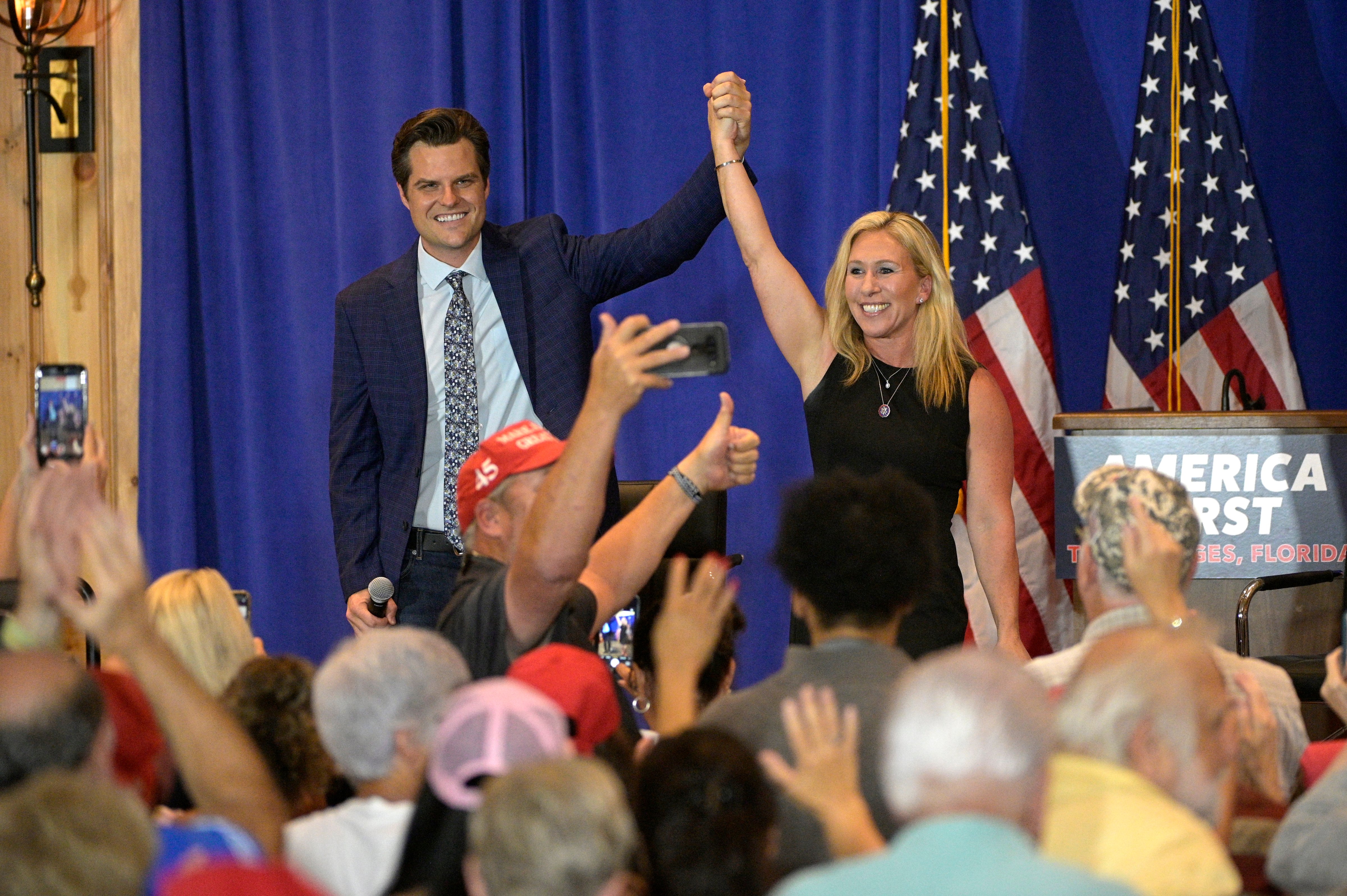 Rep. Matt Gaetz, R-Fla., left, and Rep. Marjorie Taylor Greene, R-Ga., raise their arms after addressing attendees of a rally in The Villages, Fla., on May 7, 2021, (Phelan M. Ebenhack—AP)