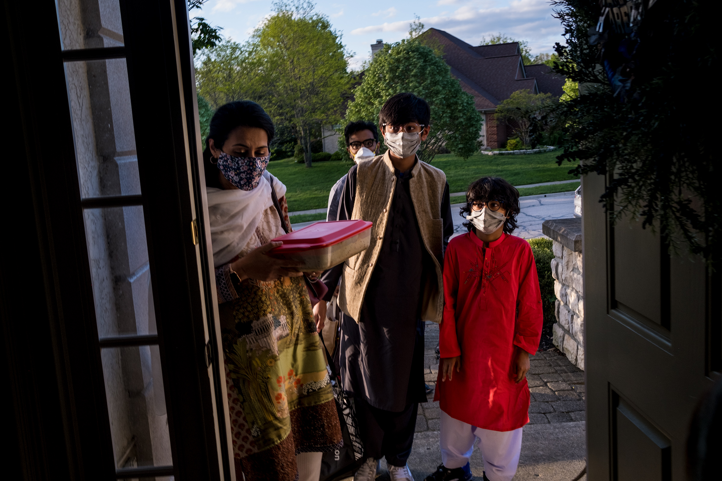 From left, Afsheen Rizvi, 45, her husband Tariq Sayed Rizvi, 45, behind, and their two sons Mahad, 12, and Arhem, 8, arrive at potluck dinner at their friend’s home in Dublin, Ohio on May 5. (Eli Hiller for TIME)
