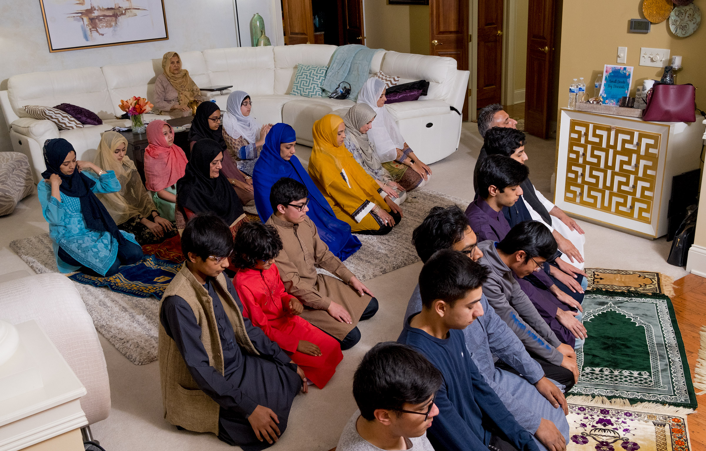 Five Muslim families perform a late-night prayer.