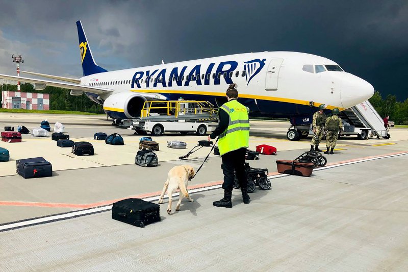 A Belarusian dog handler checks luggage after the Ryanair flight landed in Minsk on May 23.