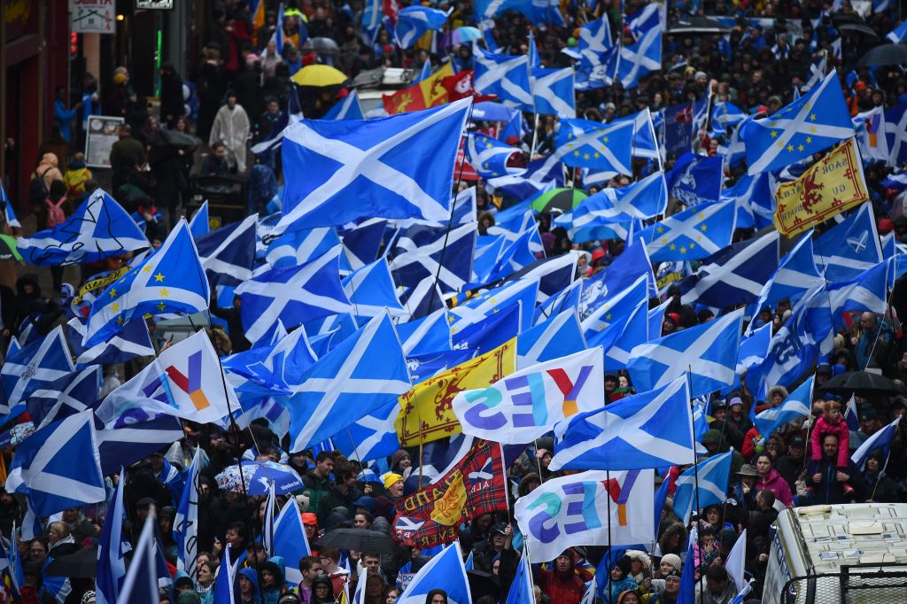 Protesters with Scottish Saltire flags attend a march calling for Scottish independence in Glasgow on January 11, 2020. (Photo by ANDY BUCHANAN/AFP via Getty Images)
