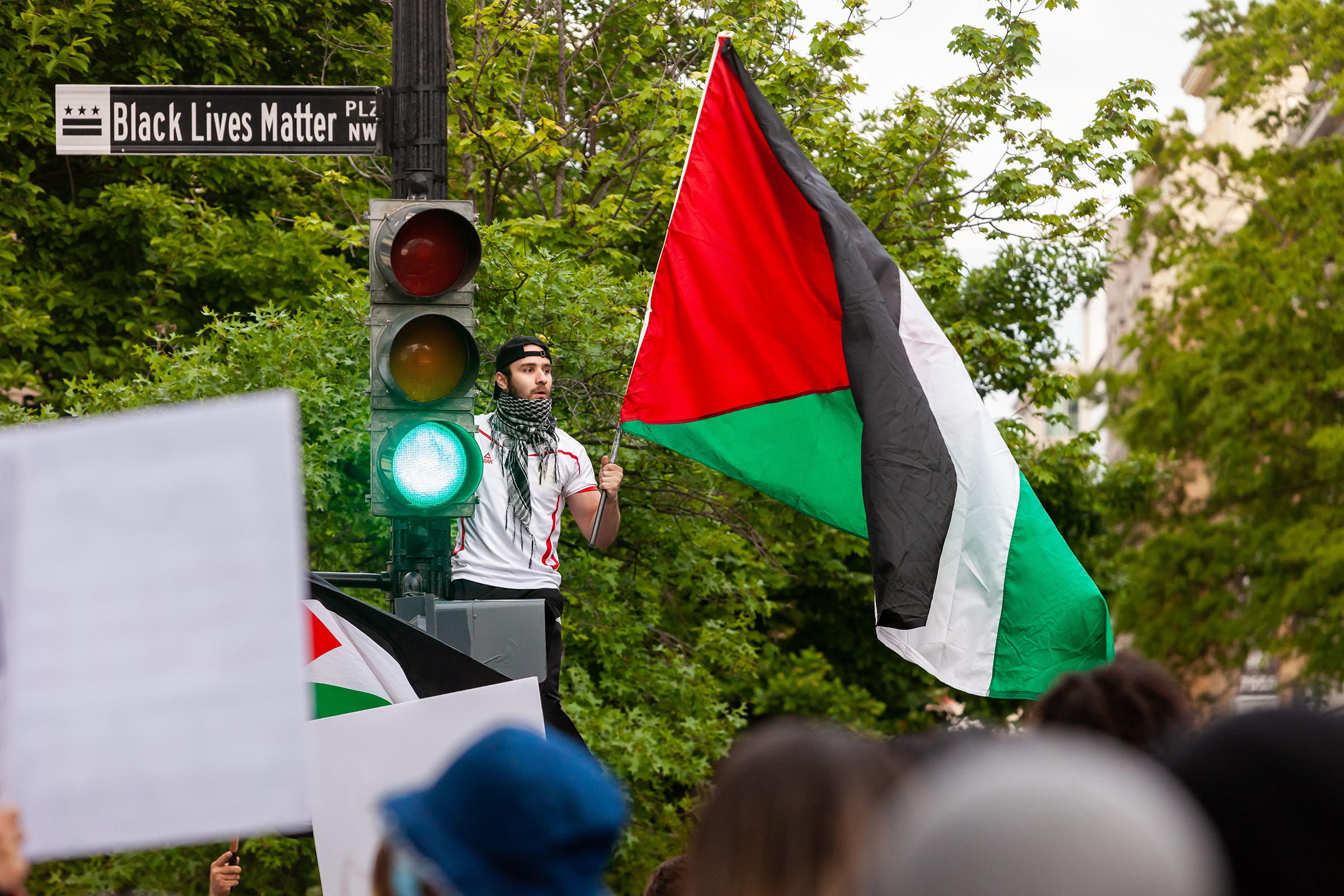 A man waves a Palestinian flag near the White House during a protest on May 11, 2021. Democratic Congresswoman Rashida Tlaib, who is of Palestinian descent, compared the Palestinian struggle to how Black Americans have risen up against police brutality in the past year. (Allison Bailey—Shutterstock)