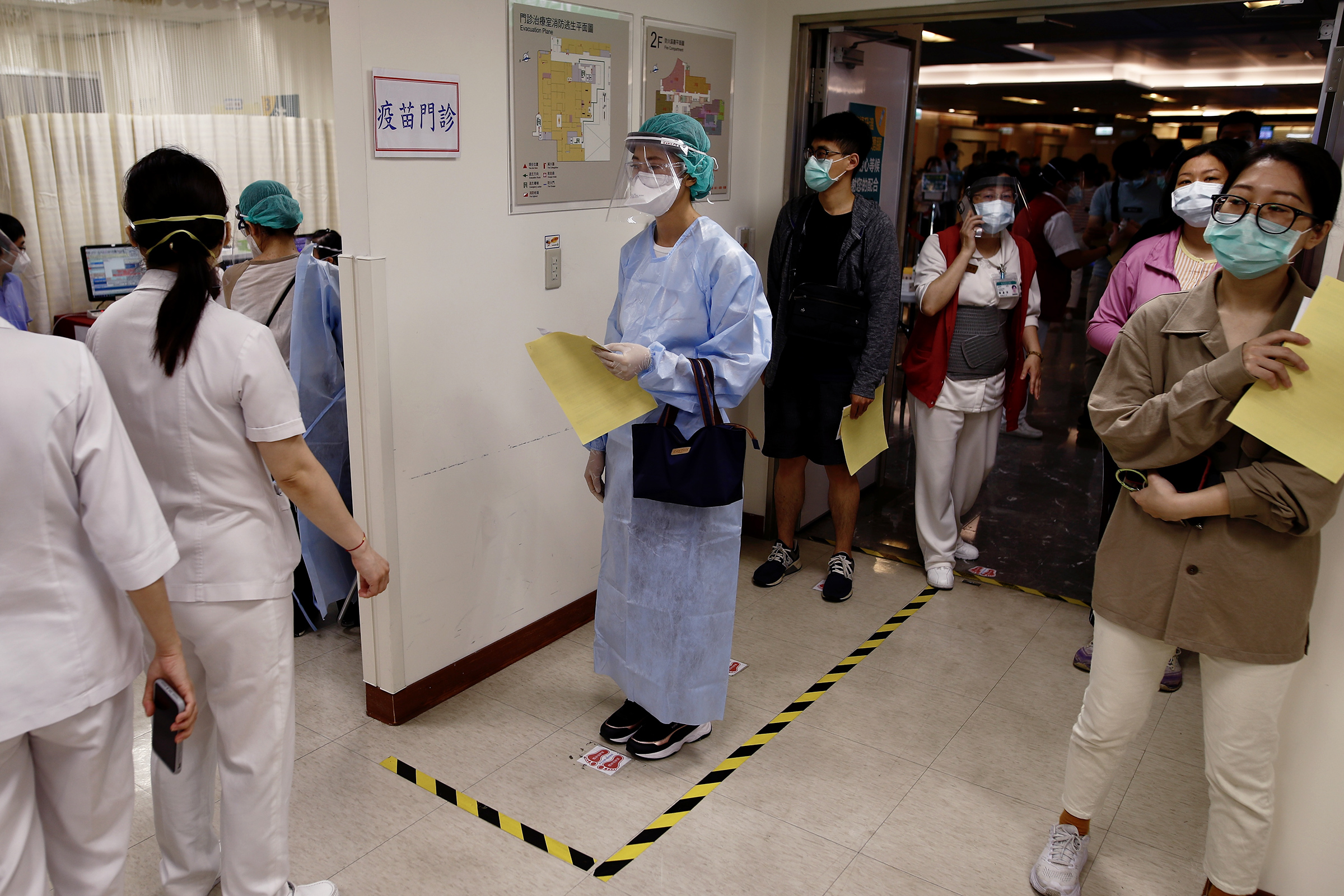Medical workers wait to receive the AstraZeneca COVID-19 vaccine at a hospital in New Taipei on May 20, 2021. Hundreds of frontline workers received the vaccine amid the rising number of cases in Taiwan.