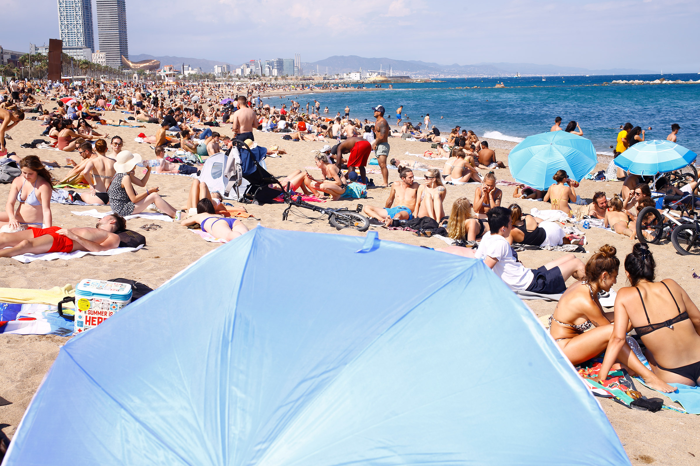 Sunbathers enjoy the busy Barceloneta Beach on June 6, 2021. (Ricardo Cases for TIME)