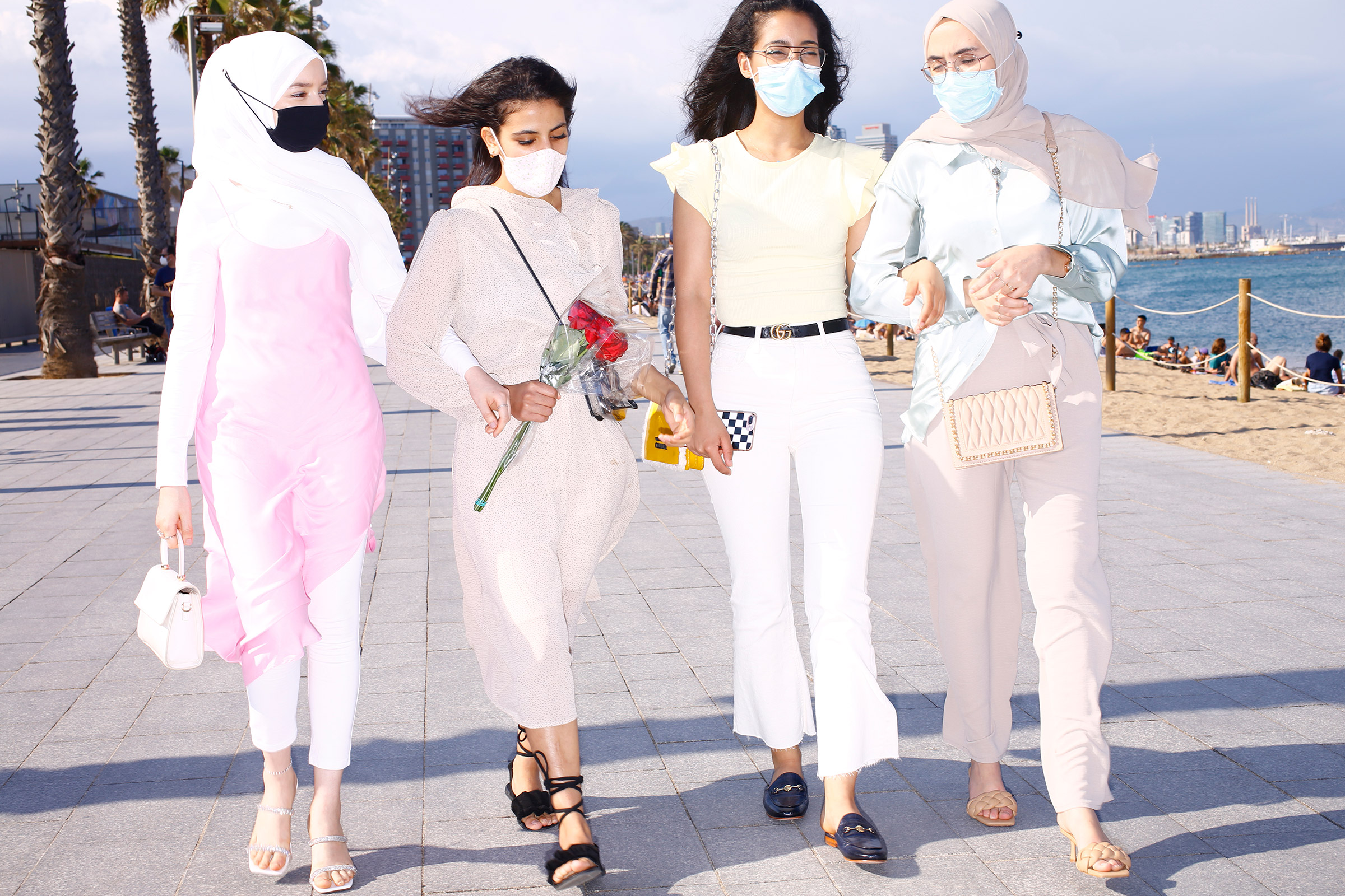 Young women stroll along Barceloneta Beach on June 6. (Ricardo Cases for TIME)